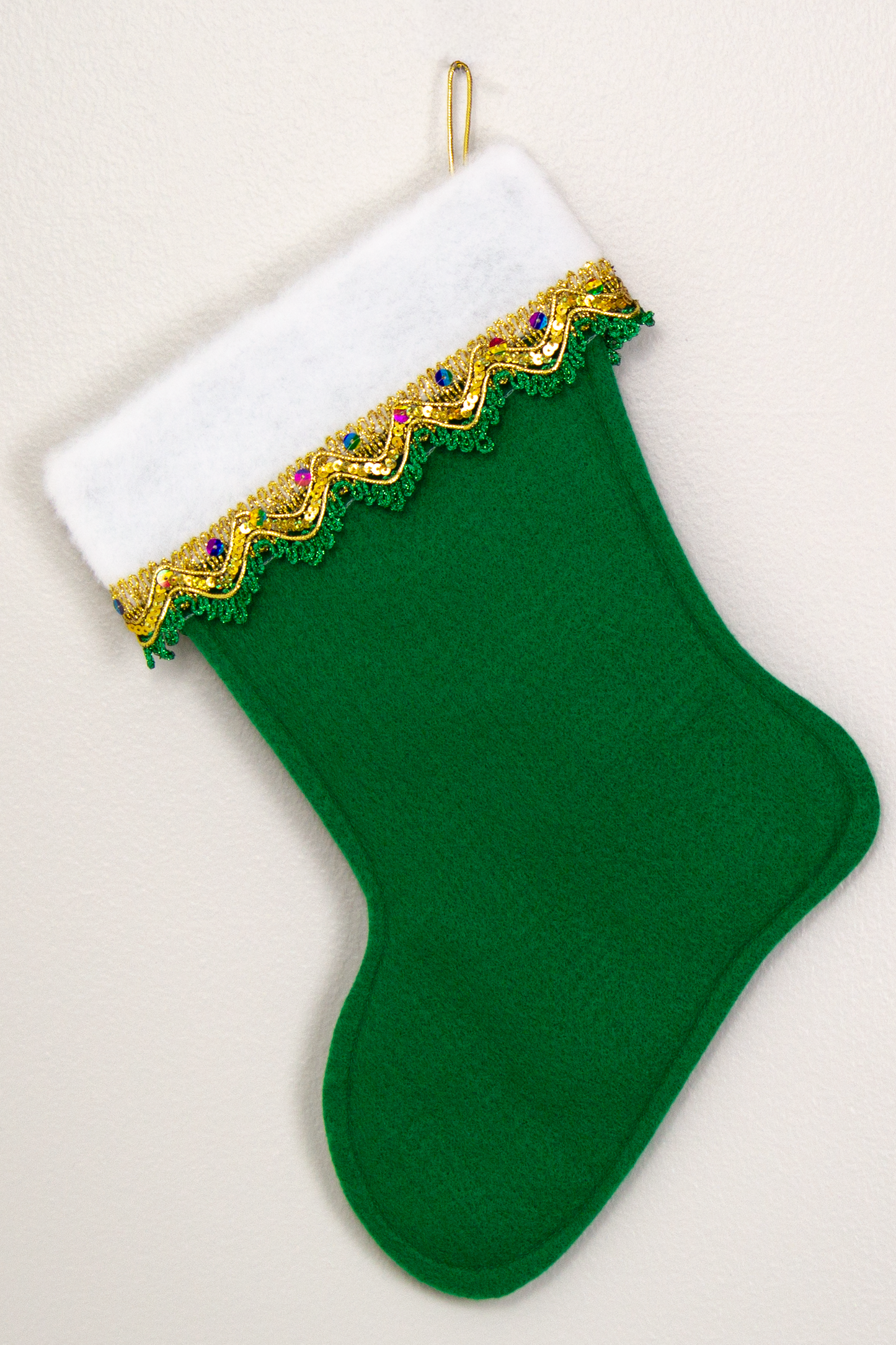 Christmas stocking on holiday green felt. (back of Bichon Frise of stocking)