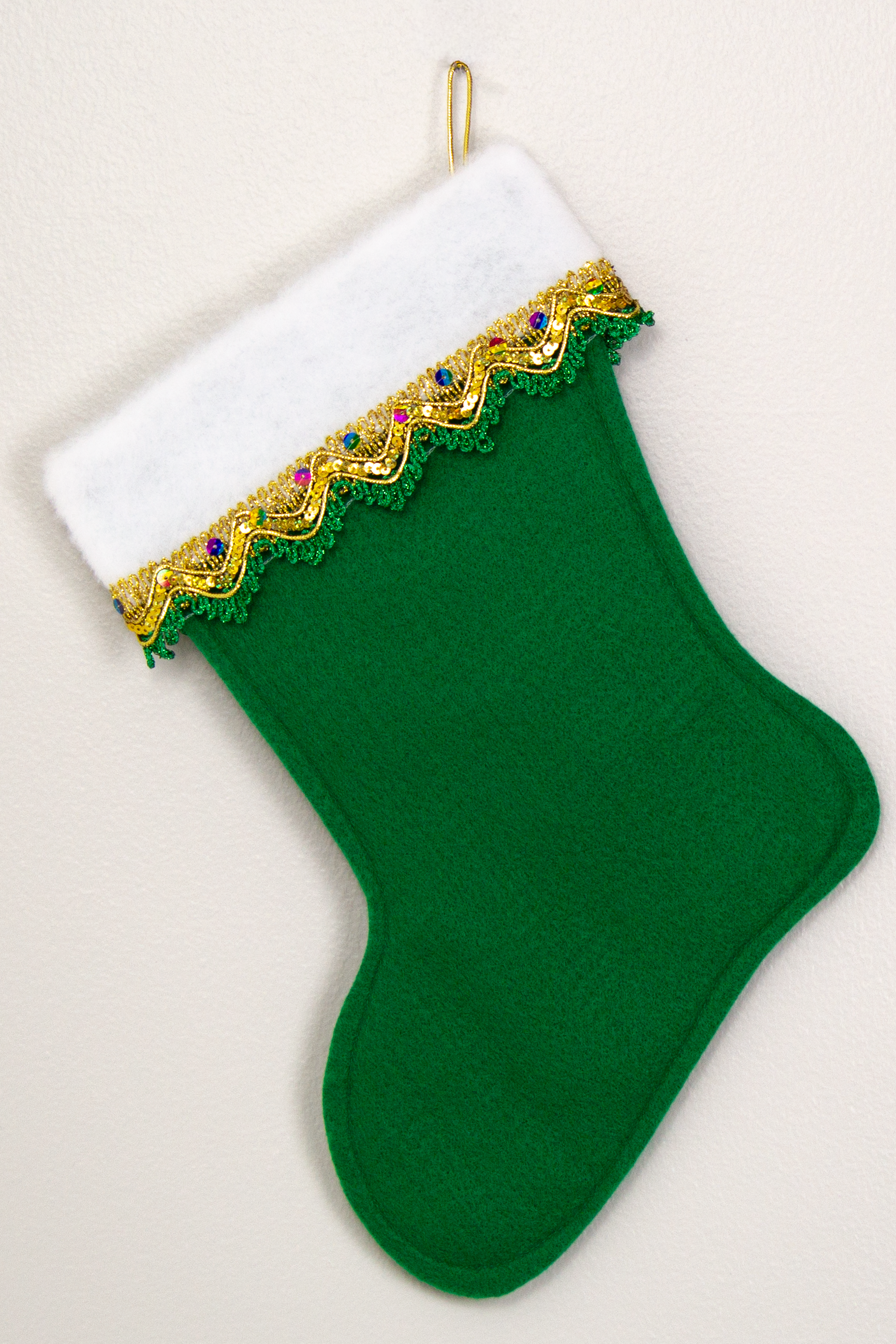 Christmas stocking on holiday green felt. (back of Bichon Frise of stocking)