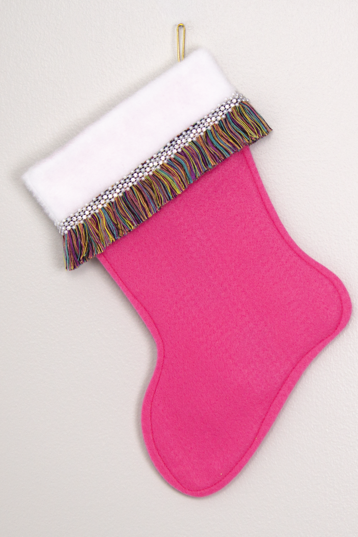 Candy pink felt handmade Christmas stocking with multicolor fringe and decorations in white, clear & gold. (back of Carousel Horse stocking)