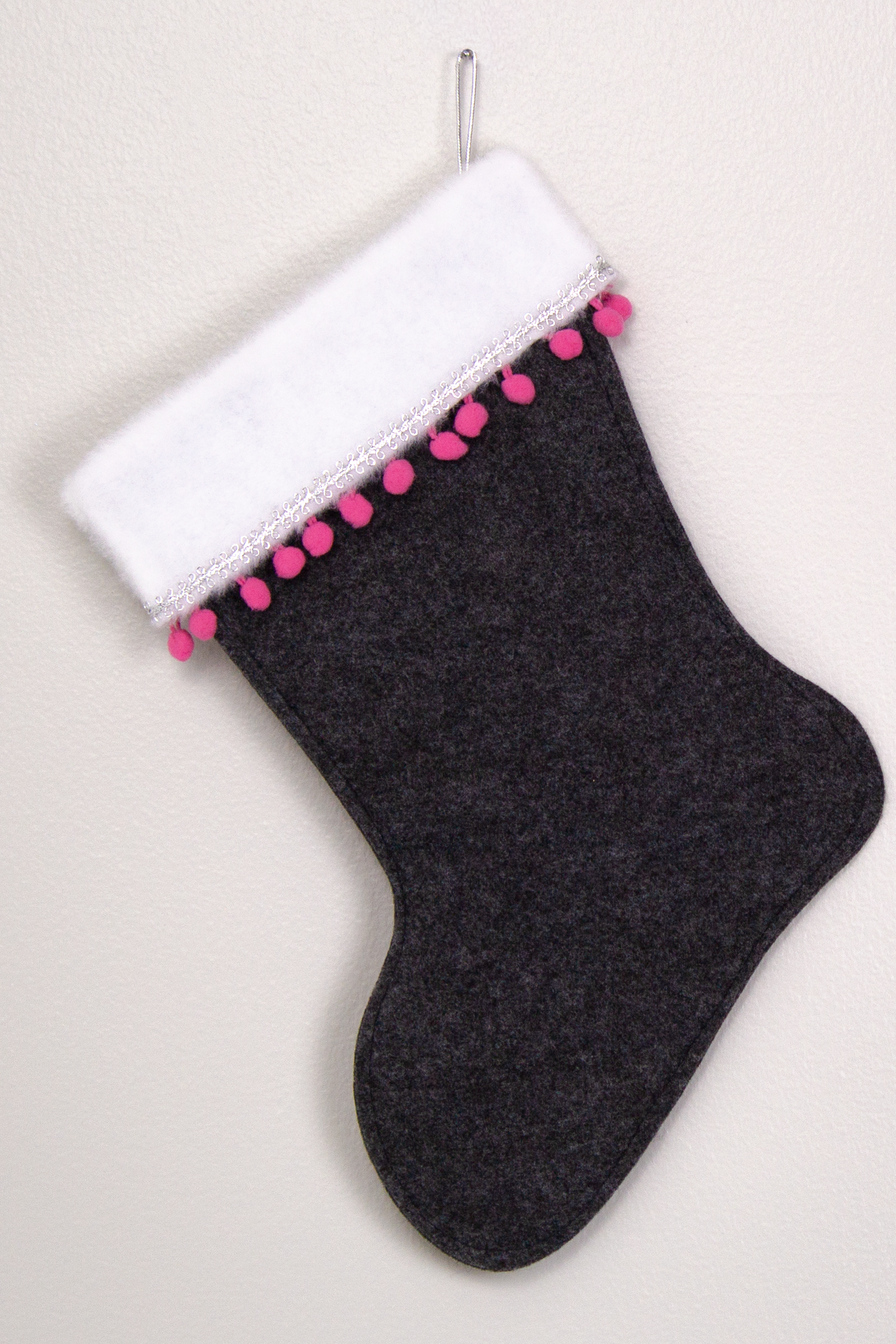 Charcoal gray felt handmade Christmas stocking with pom poms and decorations in silver and candy pink. (back of Chihuahua dog stocking)