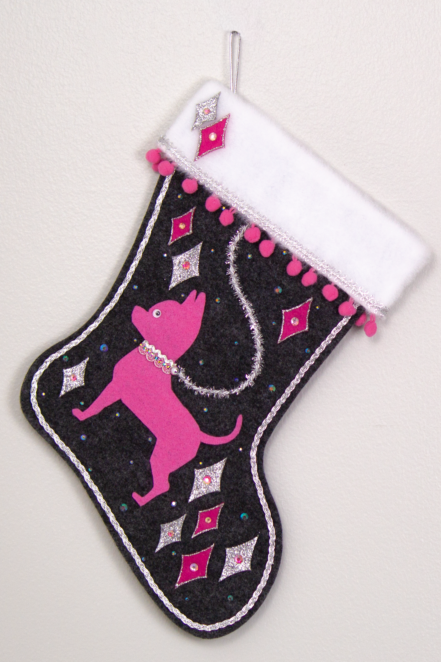 Candy pink short hair Chihuahua dog on charcoal gray felt handmade Christmas stocking with felt diamonds, pom poms and decorations in hot pink, candy pink, clear holographic and silver. (front of stocking)