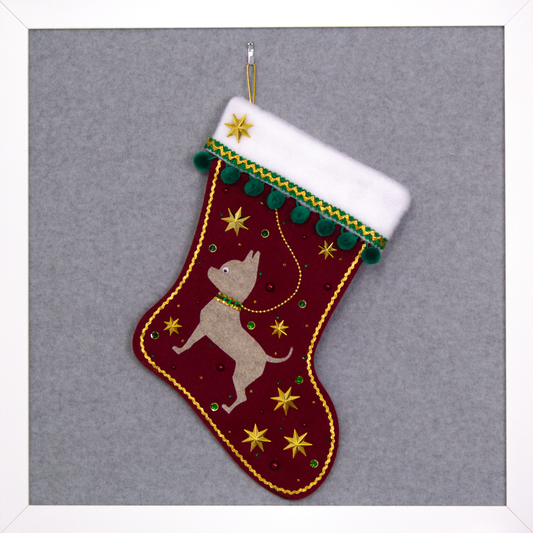Sandstone short hair Chihuahua dog on ruby red felt handmade Christmas stocking with pom poms, stars and decorated in green, dark red and gold. (front of stocking)