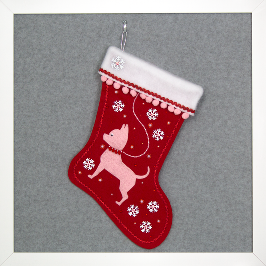 Light pink short hair Chihuahua dog felt Christmas stocking on red felt with snowflakes, pom poms and decorations in white, pink and red. (front of stocking)