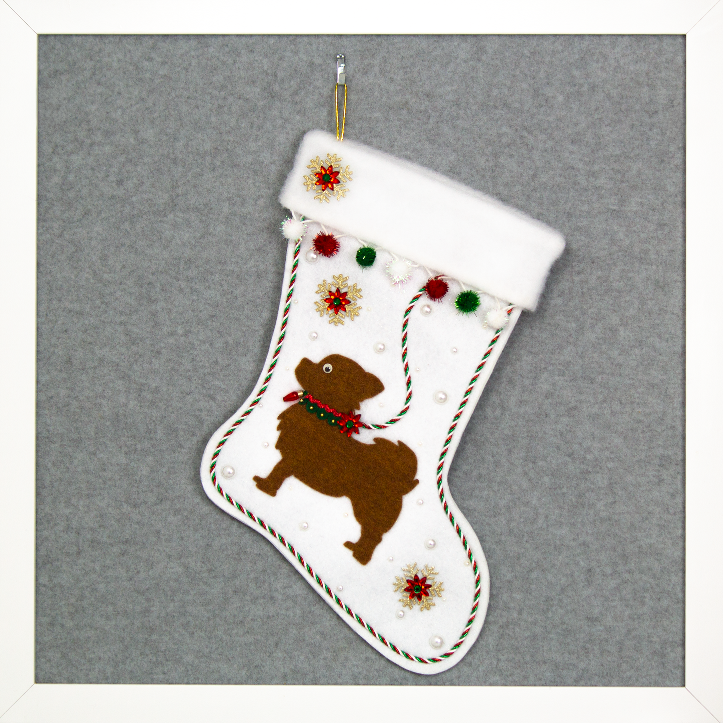 White glitter Christmas stocking with copper long hair Chihuahua small dog silhouette with sparkly pom poms, gold snowflakes, rhinestone poinsettias and decorations in green, red and gold. (front of stocking)