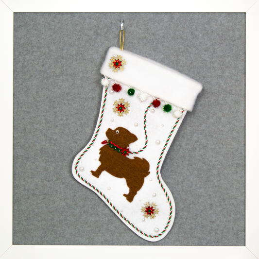 White glitter Christmas stocking with copper long hair Chihuahua small dog silhouette with sparkly pom poms, gold snowflakes, rhinestone poinsettias and decorations in green, red and gold. (front of stocking)