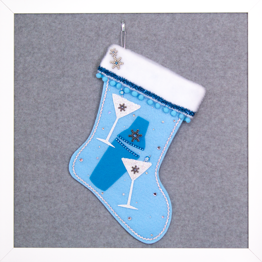 Blue felt shaker, chunky glitter painted white felt martini glasses on light blue felt handmade Christmas stocking with snowflake buttons, pom poms, tinsel ribbon and decorations in blues, white, clear & silver. (front of Cocktail stocking)