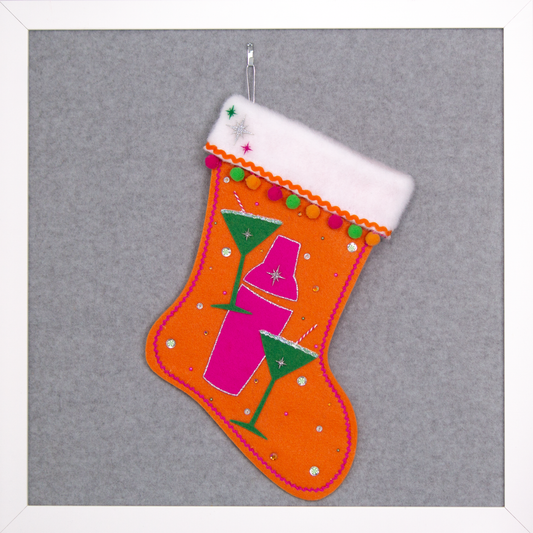 Holiday green felt martini glasses, silver glitter outlined hot pink felt shaker on orange felt handmade Christmas stocking with pom poms, acrylic starbursts and decorated in hot pink, green, orange & silver. (front of Cocktail stocking)