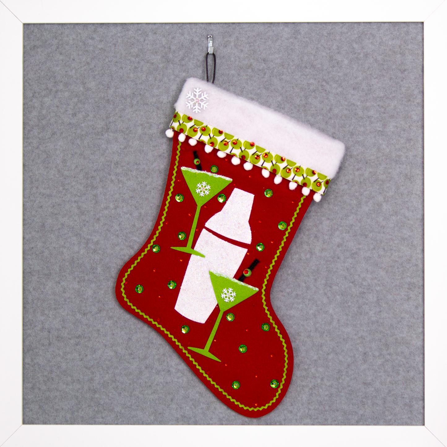 Glitter painted lime green felt martini glasses, chunky glitter painted white felt shaker on a holiday red felt handmade Christmas stocking with snowflake buttons, pom poms, olive ribbon and decorated in green, red, white, black & silver. (front of Cocktail stocking)