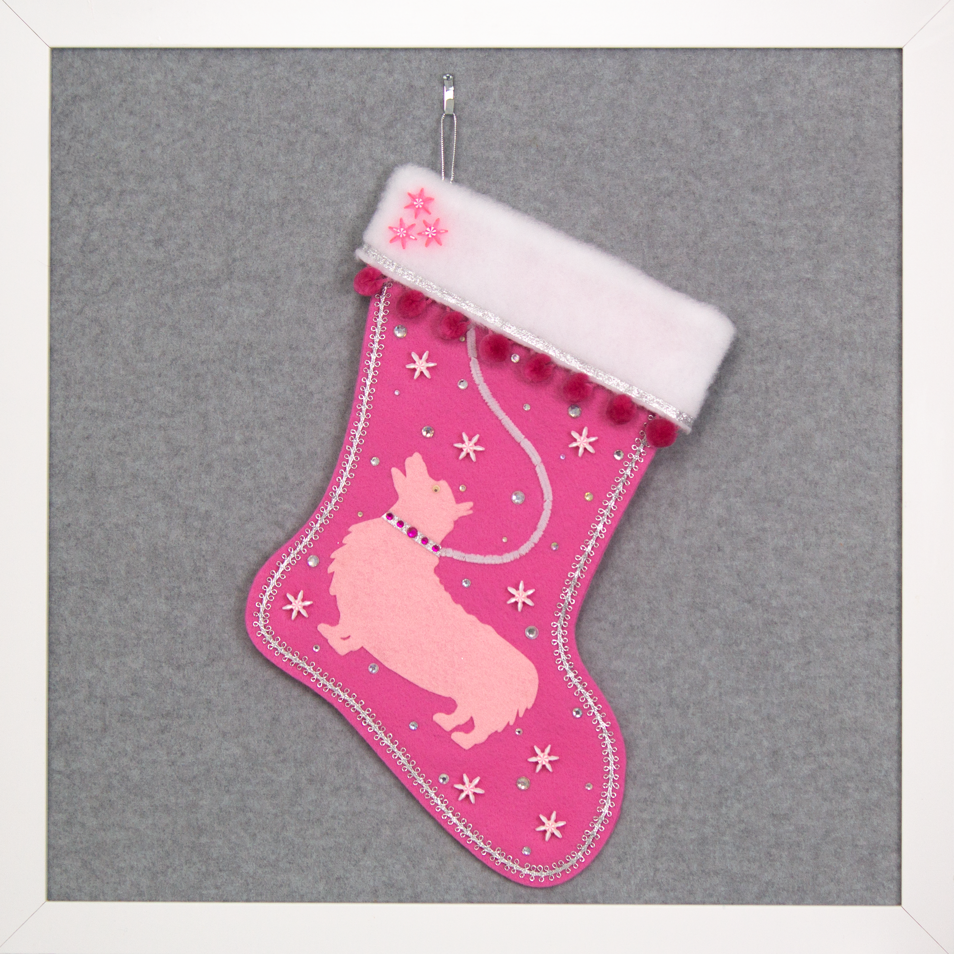 Candy pink Christmas stocking with a Corgi dog design in light pink felt, with silver, white and pink decoration. (front of stocking)