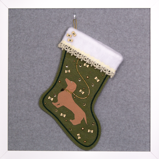 Tan Dachshund dog on olive green felt handmade Christmas stocking with laser cut felt snowflake trim, wood bone buttons and decoration in gold, cream and dark green. (front of stocking)