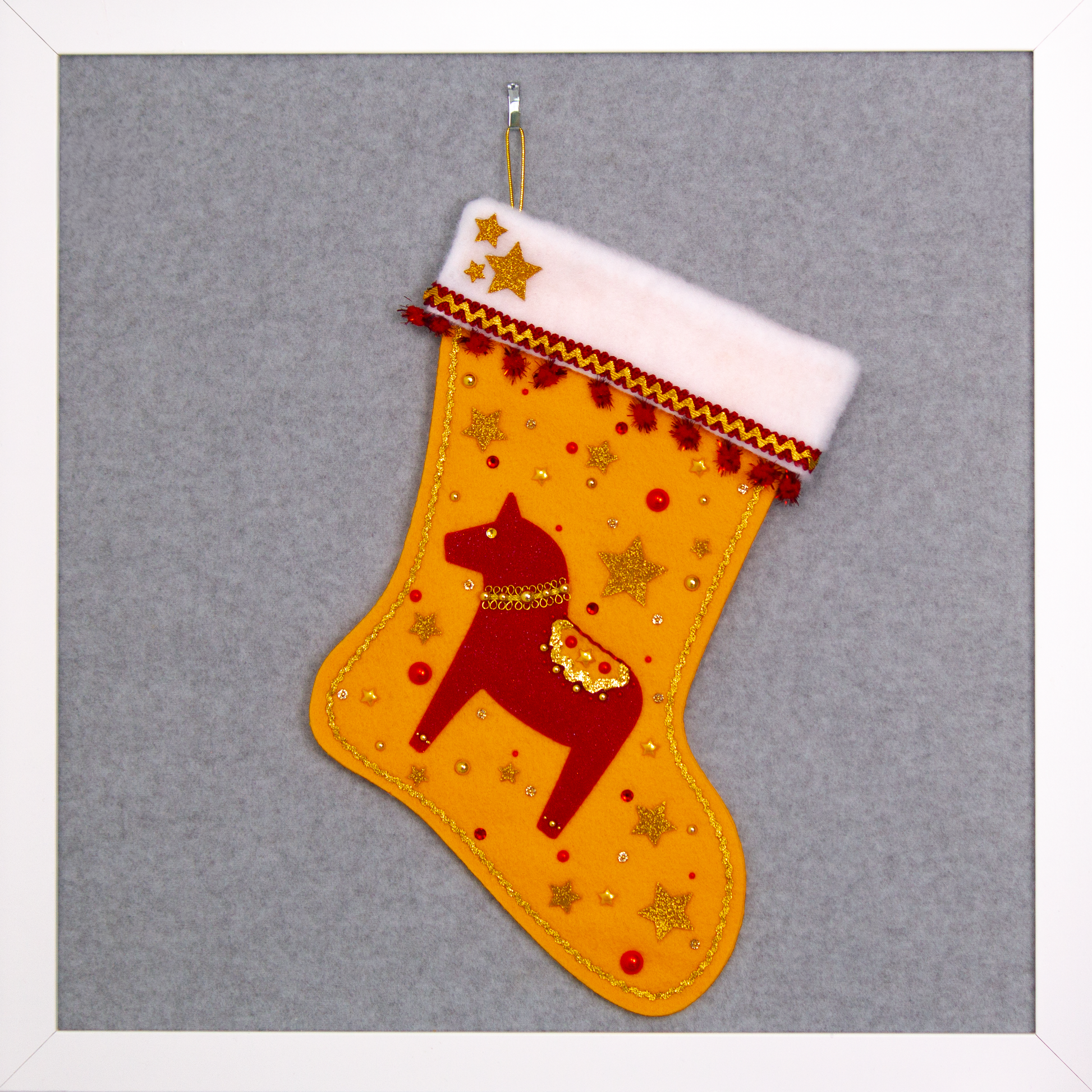 Red glitter Dala horse on gold felt handmade Christmas stocking with sparkly pom poms, gold glittered felt stars and decorated in red & gold. (front of stocking)