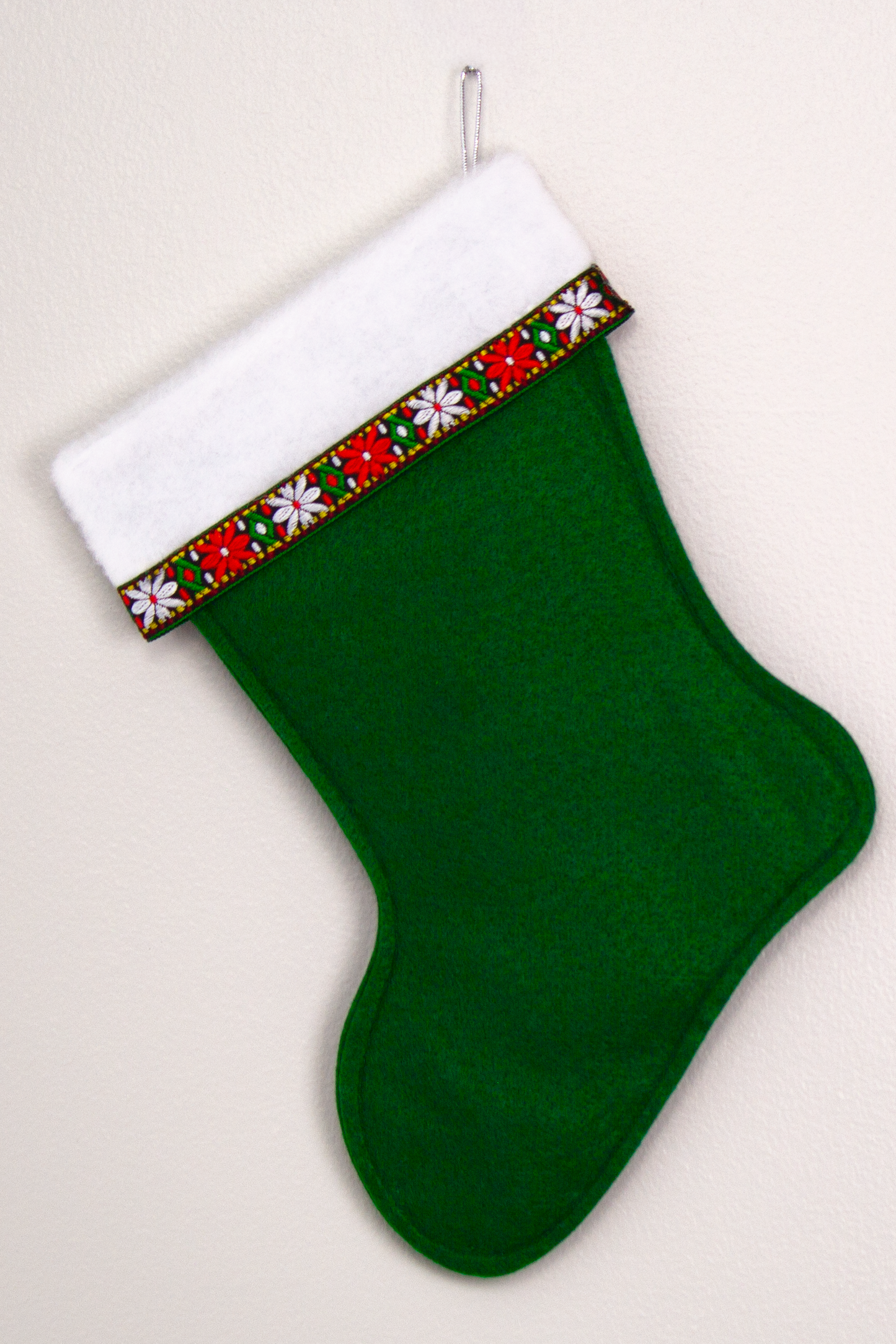 Dark green felt handmade Christmas stocking with decorative ribbon and decorated in red, green, white & silver. (back of Dala horse stocking)