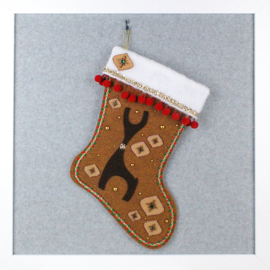 Dark brown Danish reindeer on copper canyon felt OOAK handmade Christmas stocking with red pom poms, wood starbursts, tan onion ornament shapes, and gold decoration.