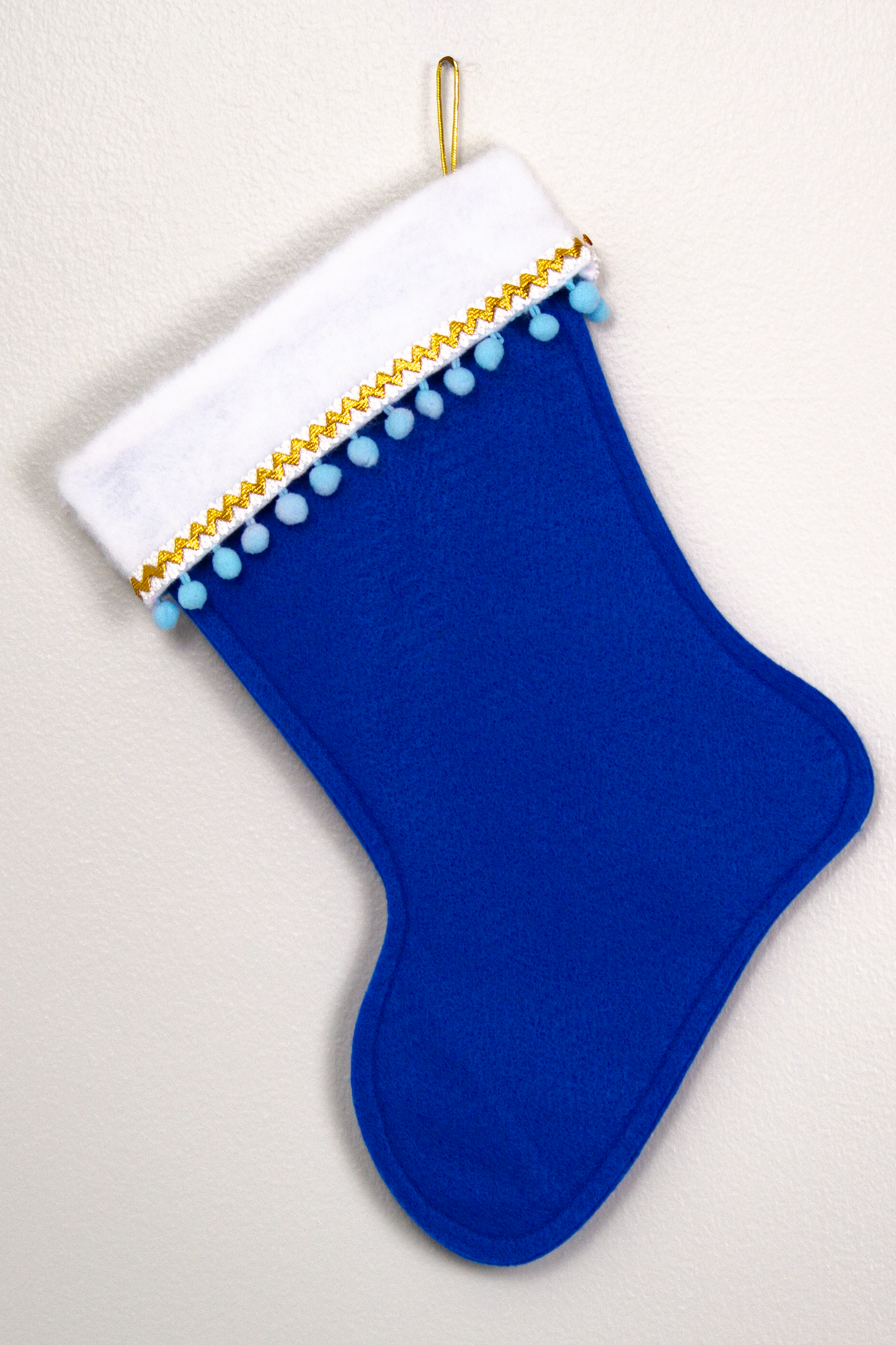 White Labradoodle dog on blue felt Christmas stocking