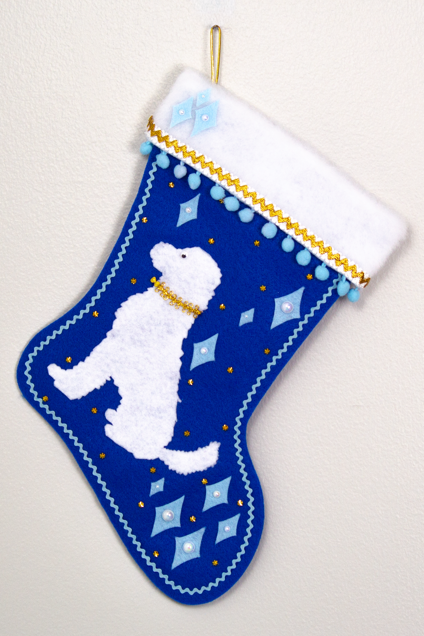 White Labradoodle dog on blue felt Christmas stocking