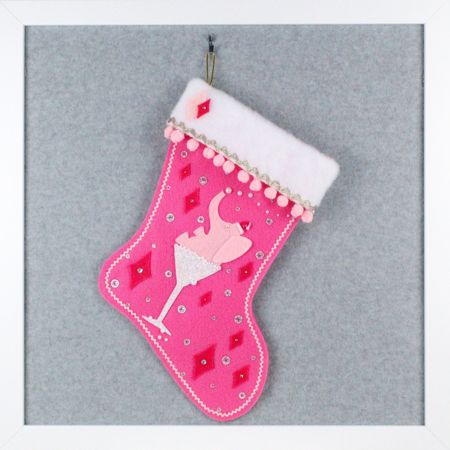 Light pink drunk elephant in a white glitter glass on candy pink felt OOAK handmade Christmas stocking with pink and silver decorations.
