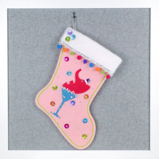 Shocking pink drunk elephant in a glitter blue glass on light pink felt one of a kind handmade Christmas stocking with multicolor pom poms and silver decoration.