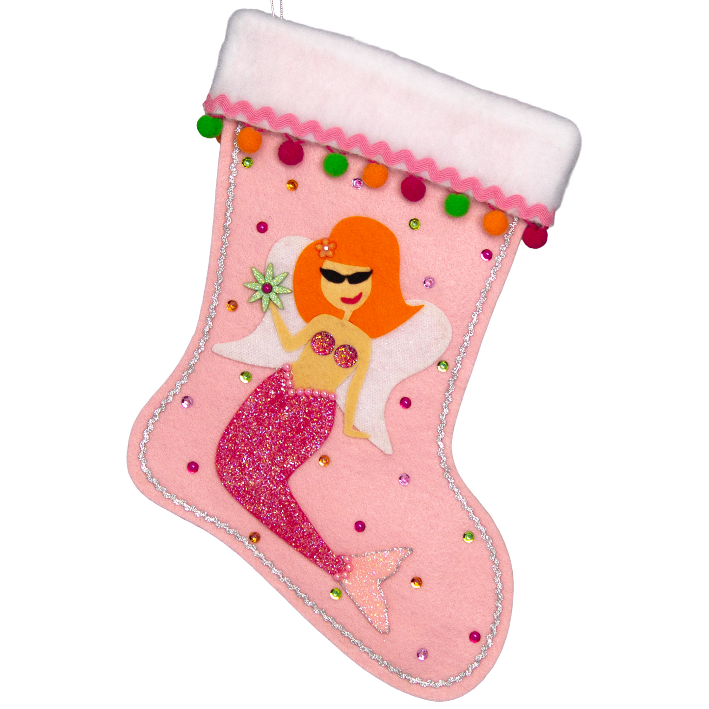 Ethel Mermaid with orange hair, glittered pink felt fin/tail, wings in white felt & glittery silver mesh, holding a sparkly flower button and a "bra" of  large multifaceted rhinestones on a light pink felt handmade Christmas stocking decorated in green, orange, pinks & silver. (front of stocking)