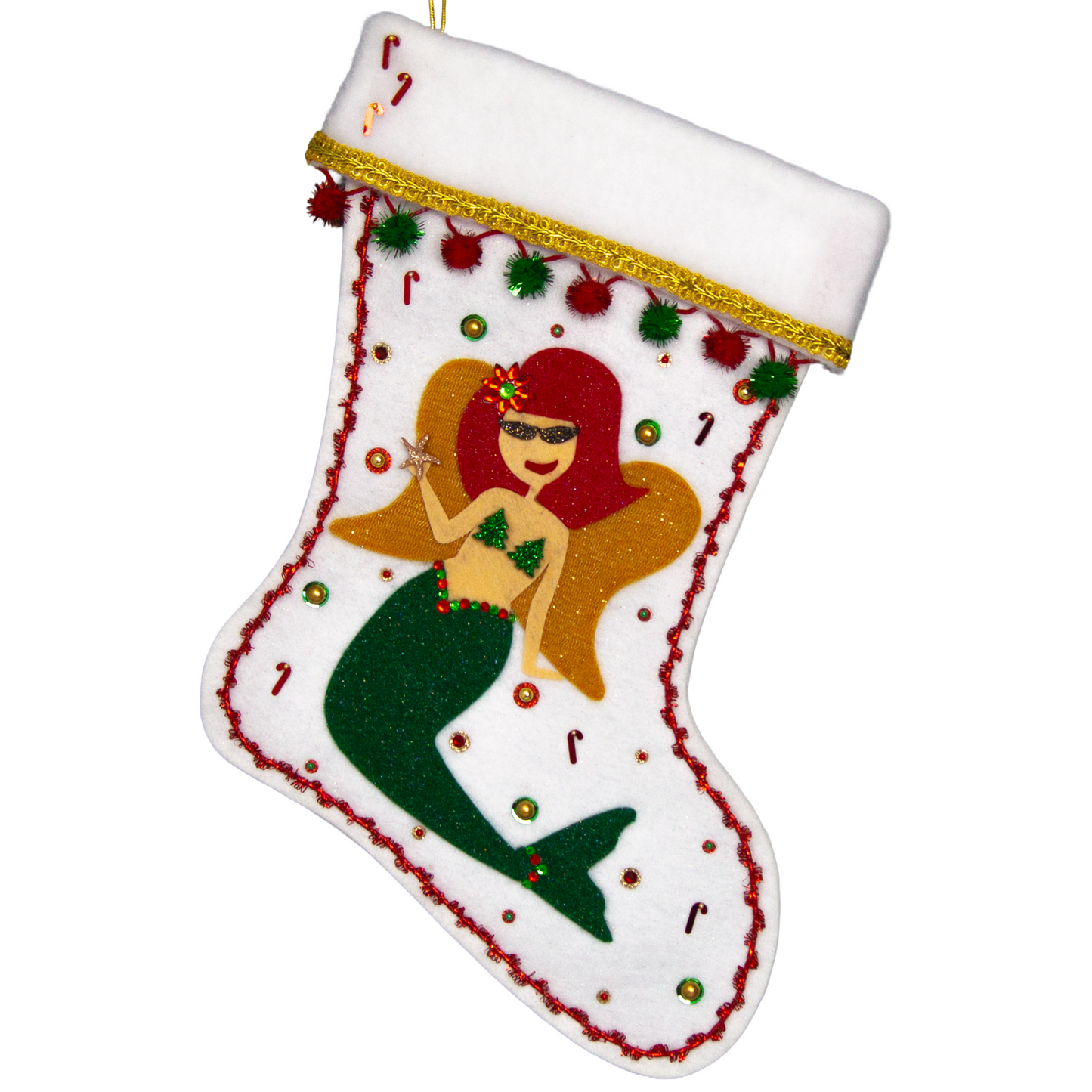 Ethel Mermaid with glitter felt red hair, dark green glitter felt fin/tail, wings in gold felt & glittery gold mesh, holding a sparkly starfish button and a "bra" of acrylic green glitter trees on a white glitter felt handmade Christmas stocking decorated in  red, green & gold. (front of stocking)
