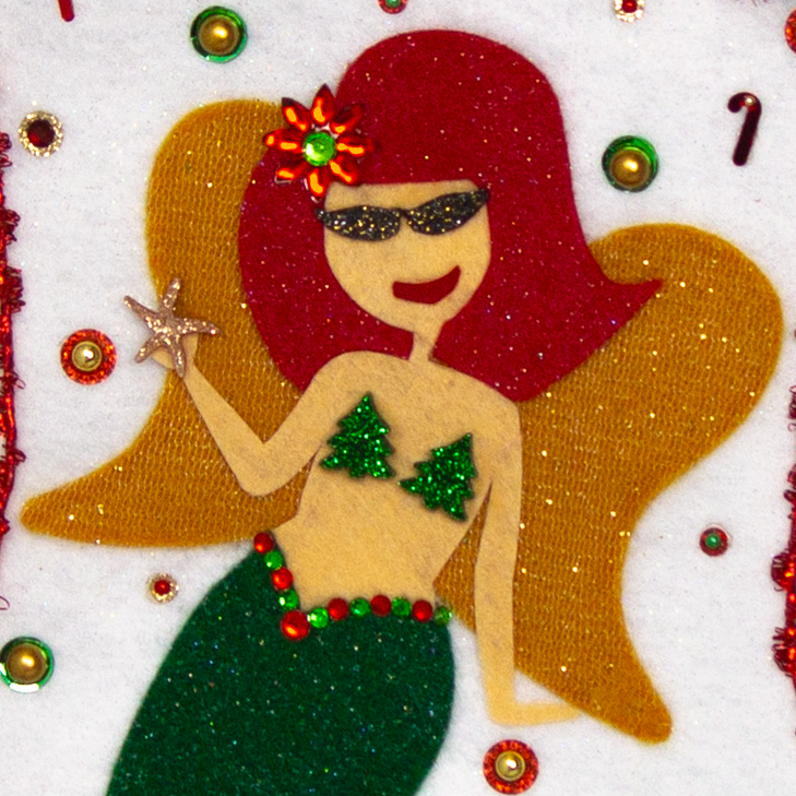 Ethel Mermaid with glitter felt red hair, dark green glitter felt fin/tail, wings in gold felt & glittery gold mesh, holding a sparkly starfish button and a "bra" of acrylic green glitter trees on a white glitter felt handmade Christmas stocking decorated in  red, green & gold. (front of stocking - close up detail of mermaid)