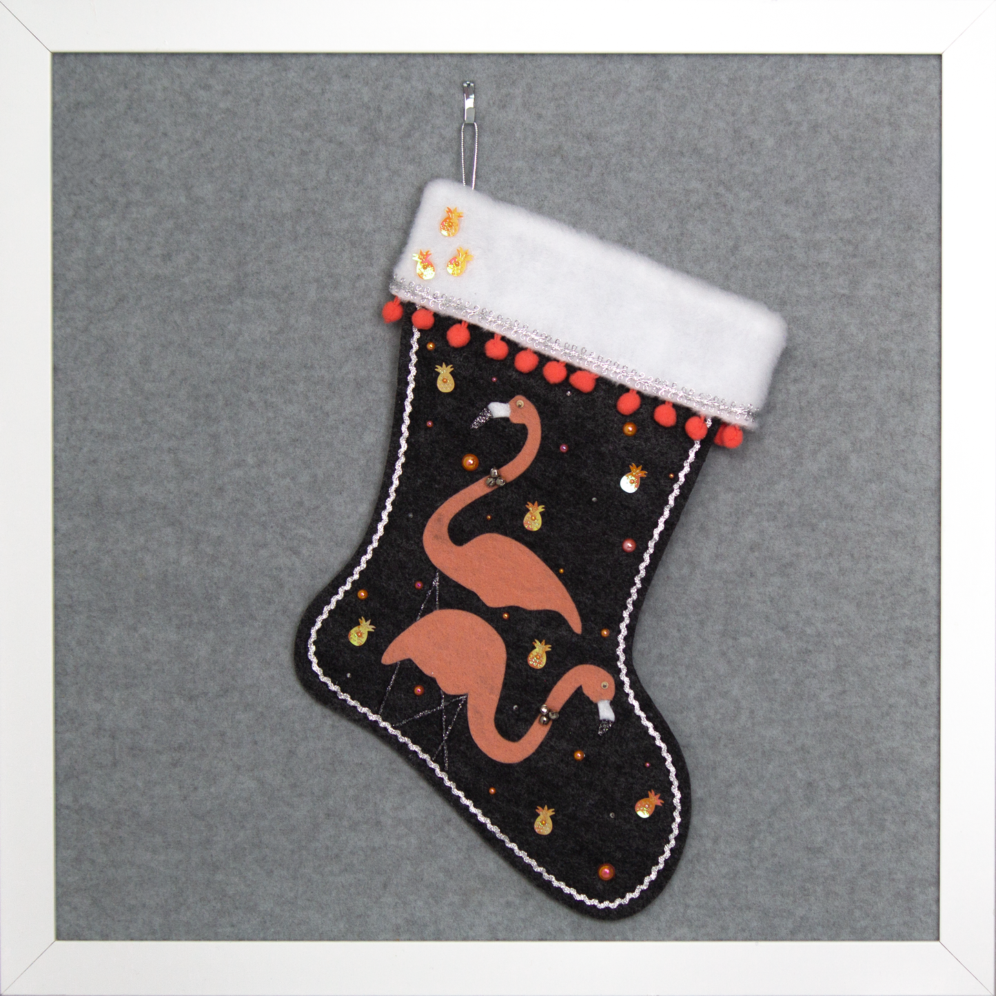 Coral flamingos on charcoal gray felt handmade Christmas stocking with pom poms, pineapple sequins and decorated in coral, black & silver. (front of stocking)