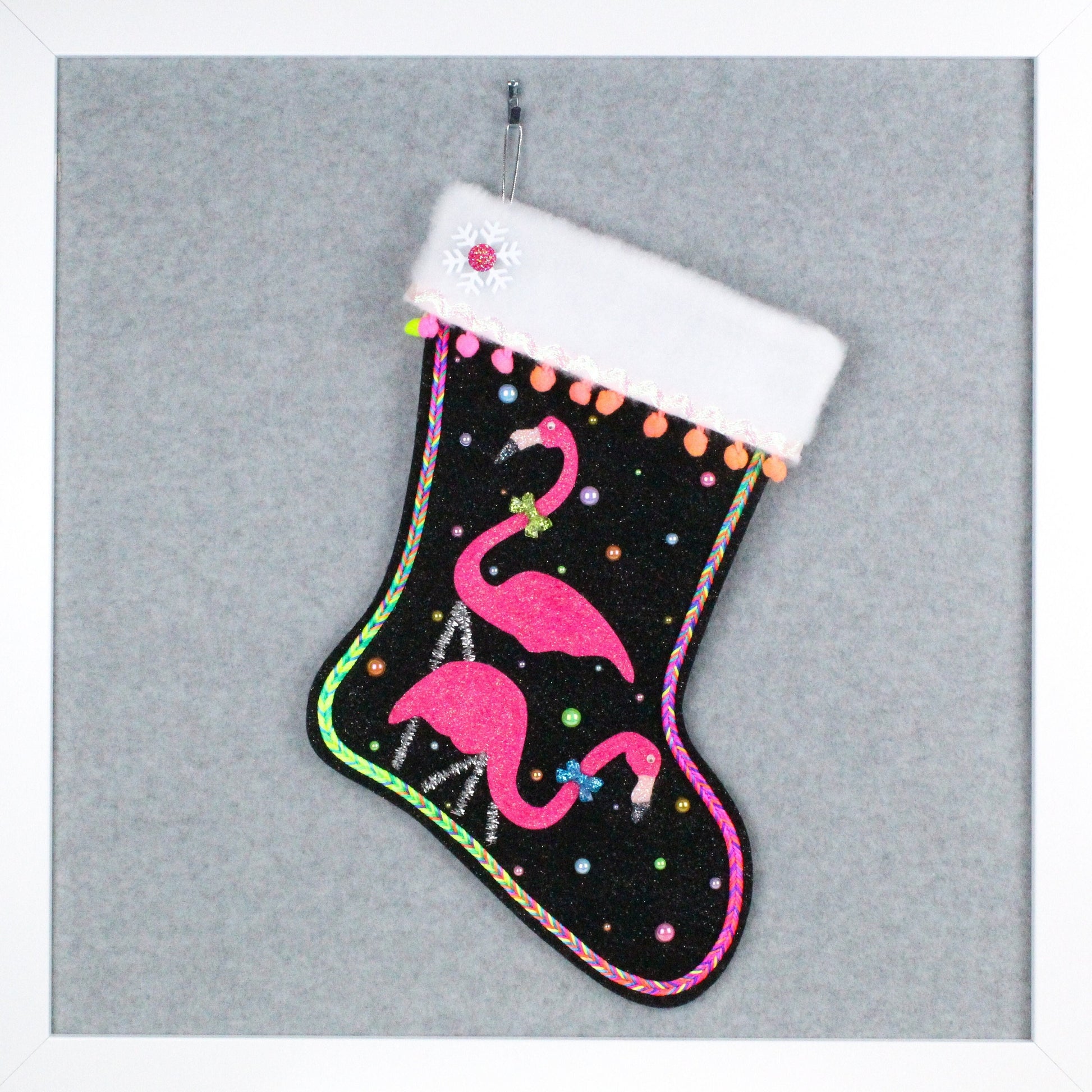 Neon pink glittery flamingos on black glitter felt handmade OOAK Christmas stocking with silver and bright rainbow decorations.