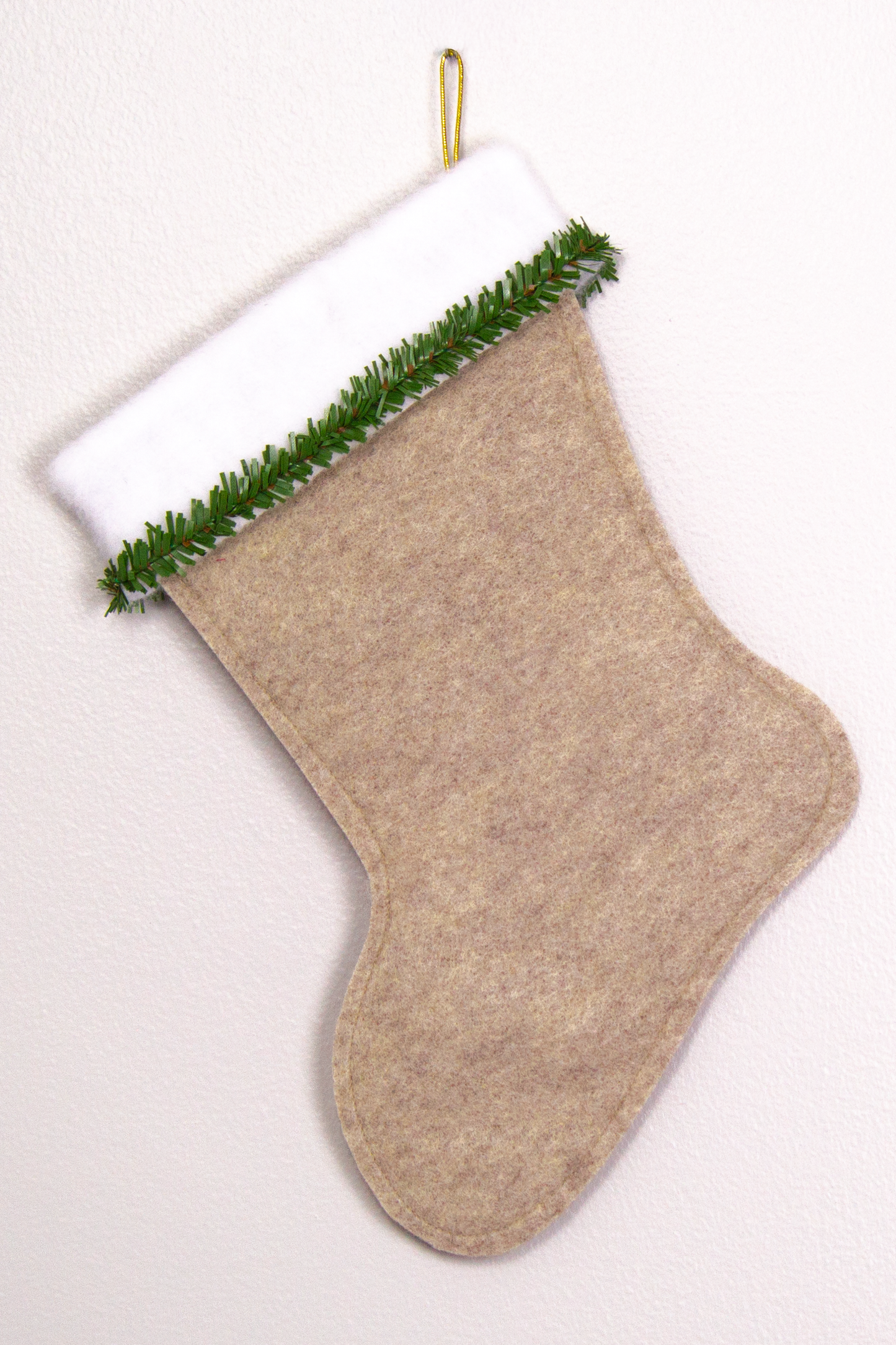 Sandstone beige felt handmade Christmas stocking with faux pine trim and decoration in green and gold. (back of German Shepherd dog stocking)