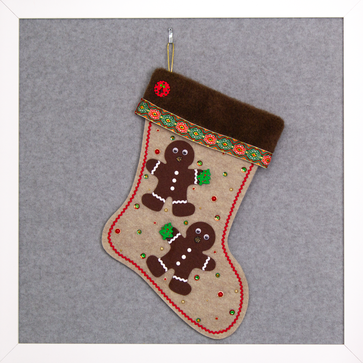 Twin dark brown Gingerbread men on sandstone beige felt handmade Christmas stocking with brown fur trim, decorative ribbon, tree buttons, a wreath button and decorated in red, green, white & gold. (front of stocking)