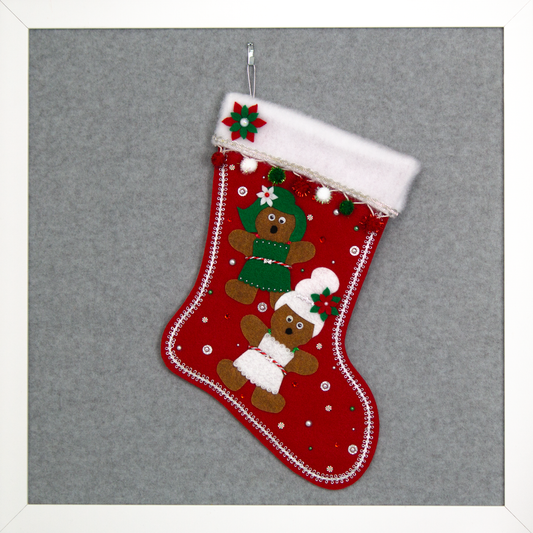 Twin copper felt Gingerbread on a holiday red felt handmade Christmas stocking with sparkly pom poms, felt poinsettias and decorated in white, green, red & silver. (front of stocking)