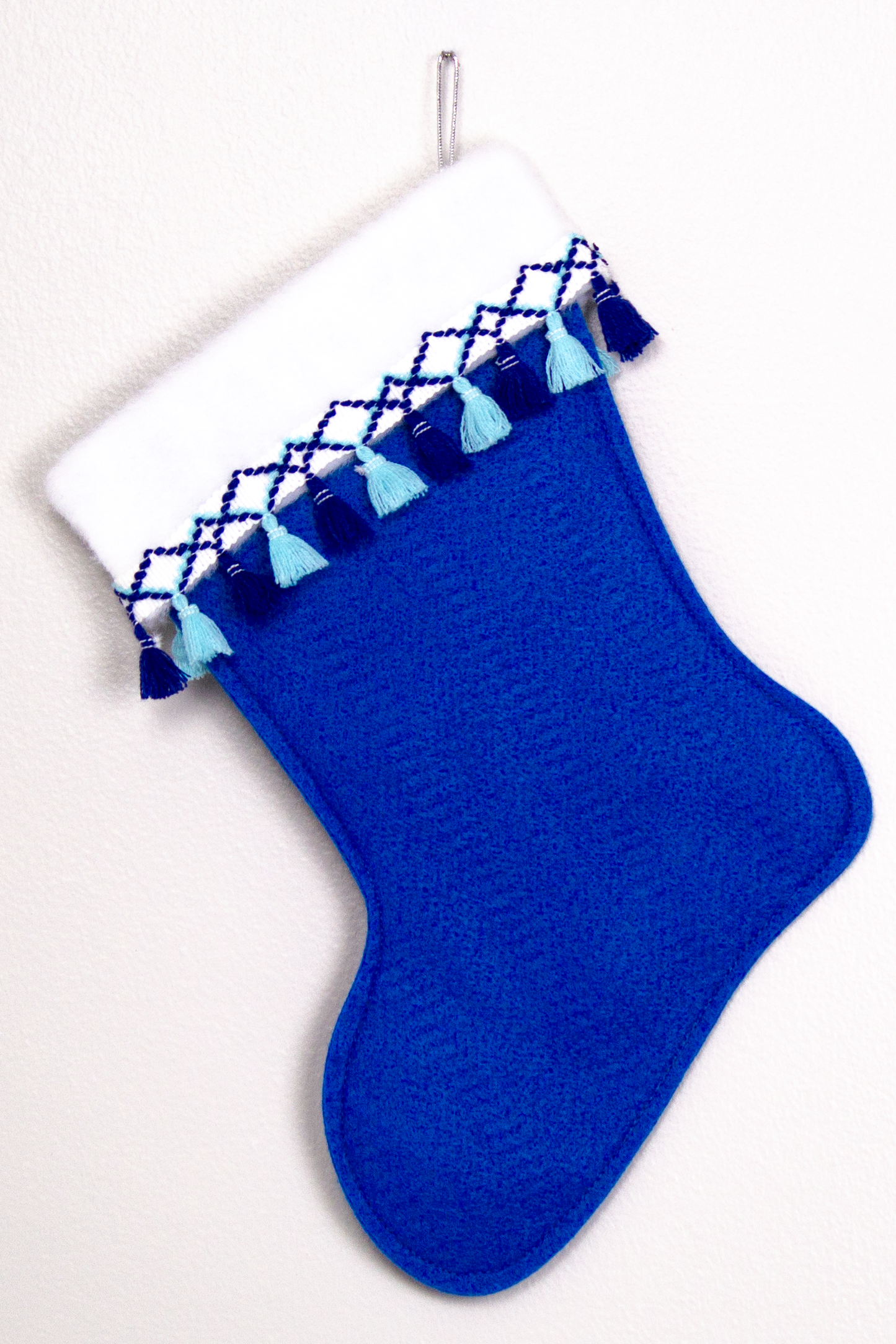 Royal blue felt handmade Christmas stocking with fringe and decoration in silver, white and blues. (back of Glen of Imaal Terrier dog stocking)
