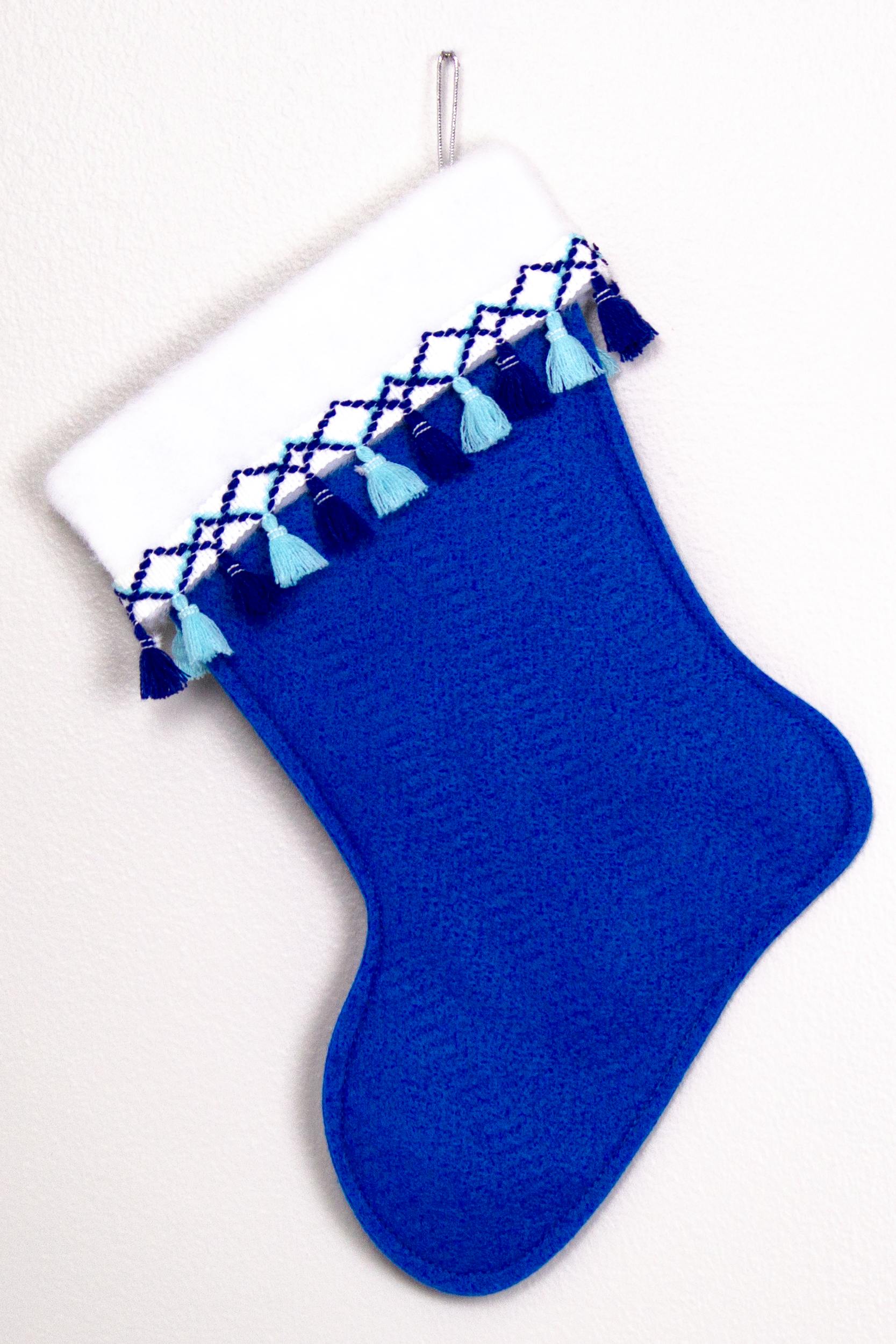Royal blue felt handmade Christmas stocking with fringe and decoration in silver, white and blues. (back of Glen of Imaal Terrier dog stocking)