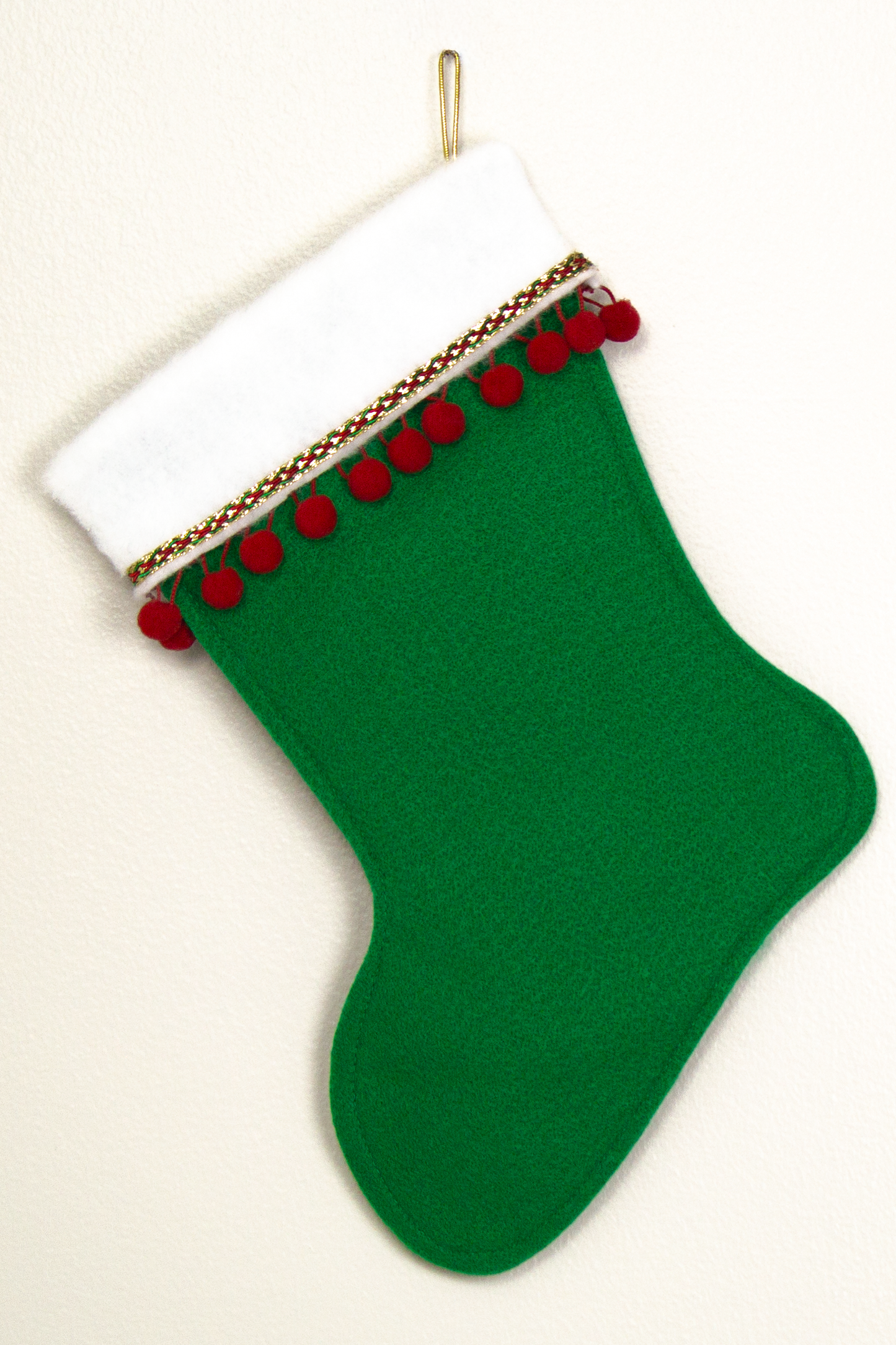 Holiday green felt handmade Christmas stocking with pom poms and decorated in green, red and gold. (back of Great Dane dog stocking)