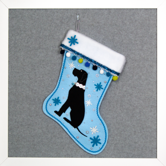 Black Great Dane dog on light blue felt handmade Christmas stocking with felt starbursts, pom poms, tinsel and decorated in white, blues, green and silver. (front of stocking)