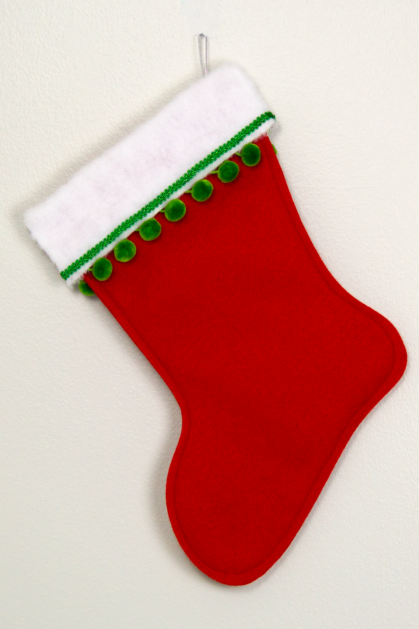 White Pomeranian dog on red felt Christmas stocking