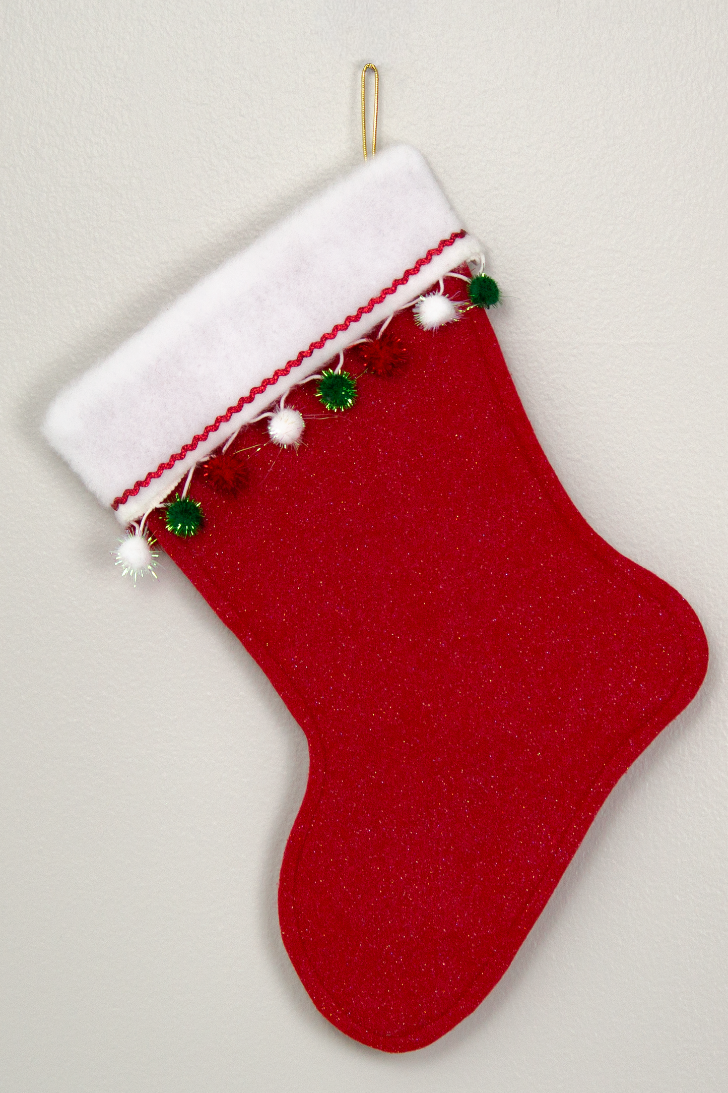 Back of red glitter Christmas stocking with white poodle design