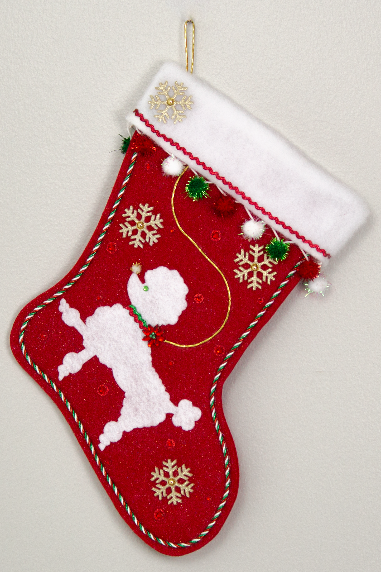 Red glitter Christmas stocking with white poodle design