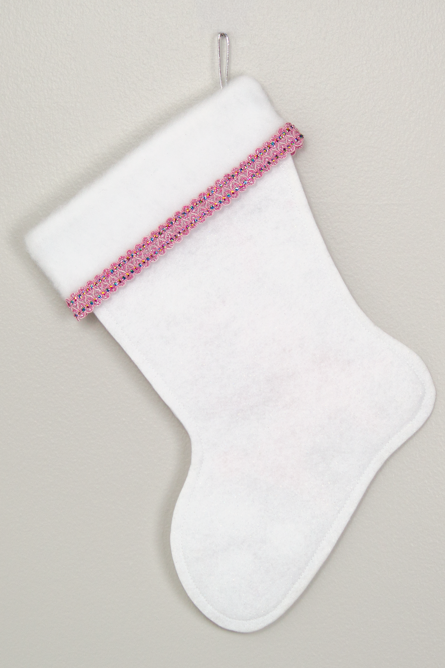 Back of white Christmas stocking with light pink poodle dog design