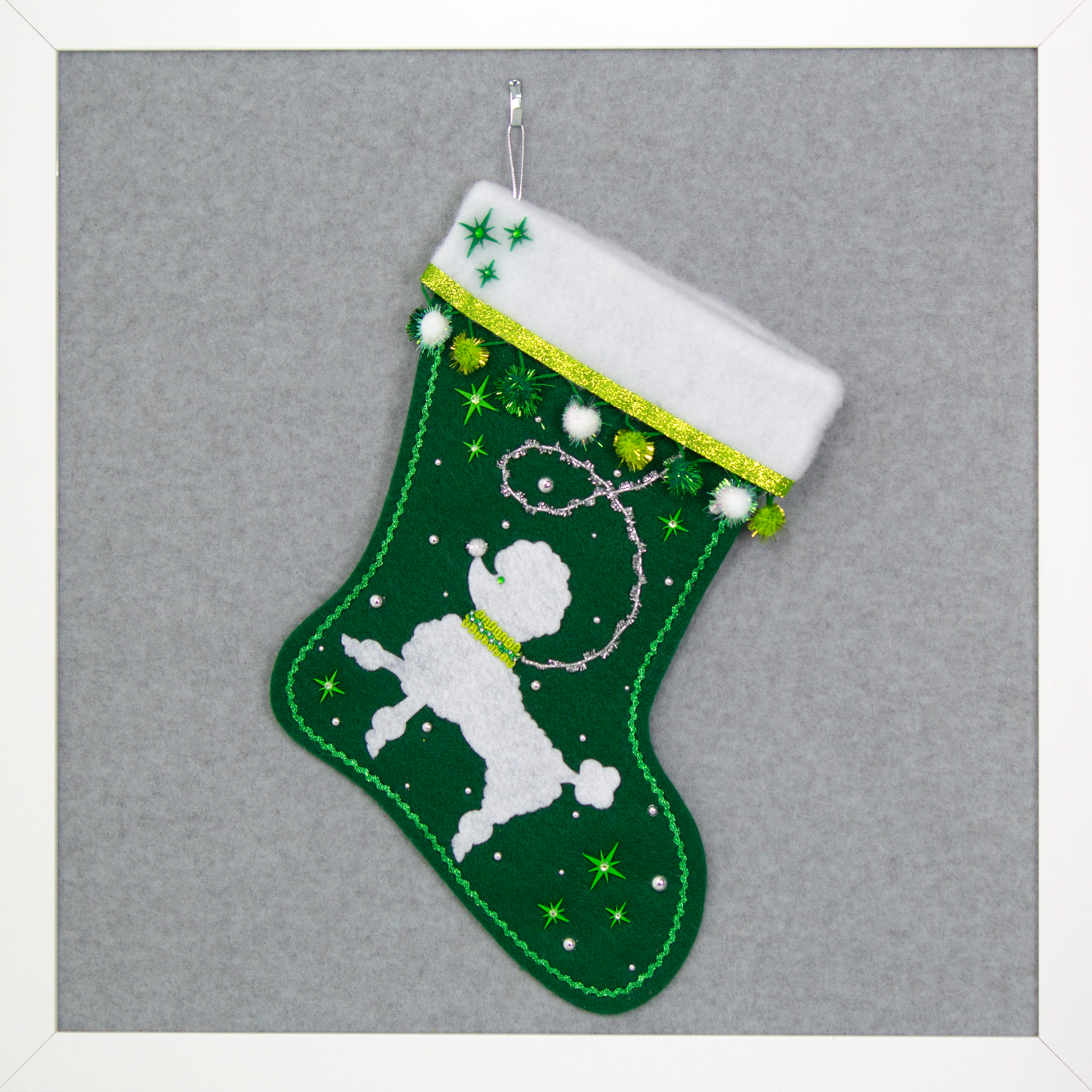 Green Christmas stocking with white poodle design
