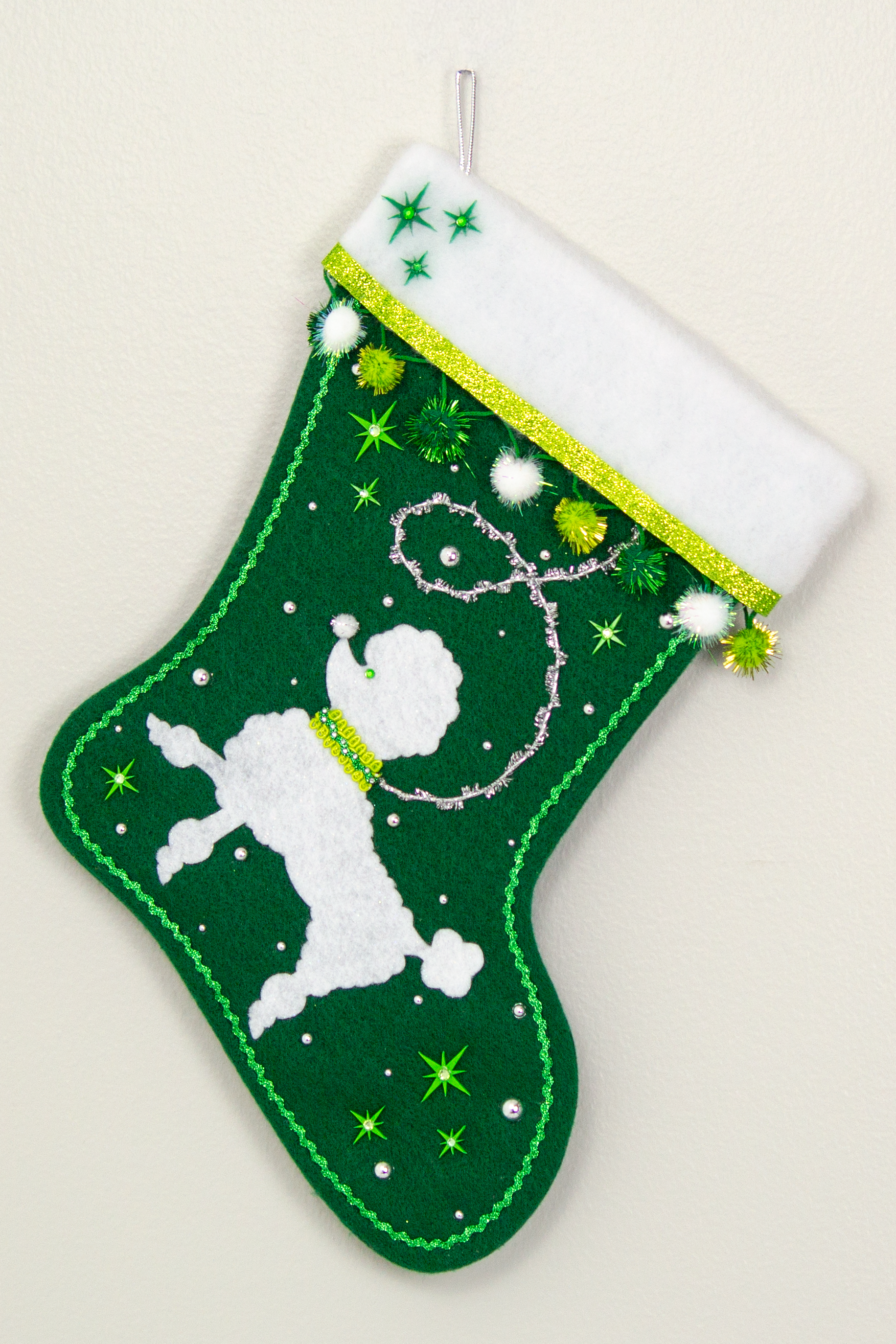 Green Christmas stocking with white poodle design