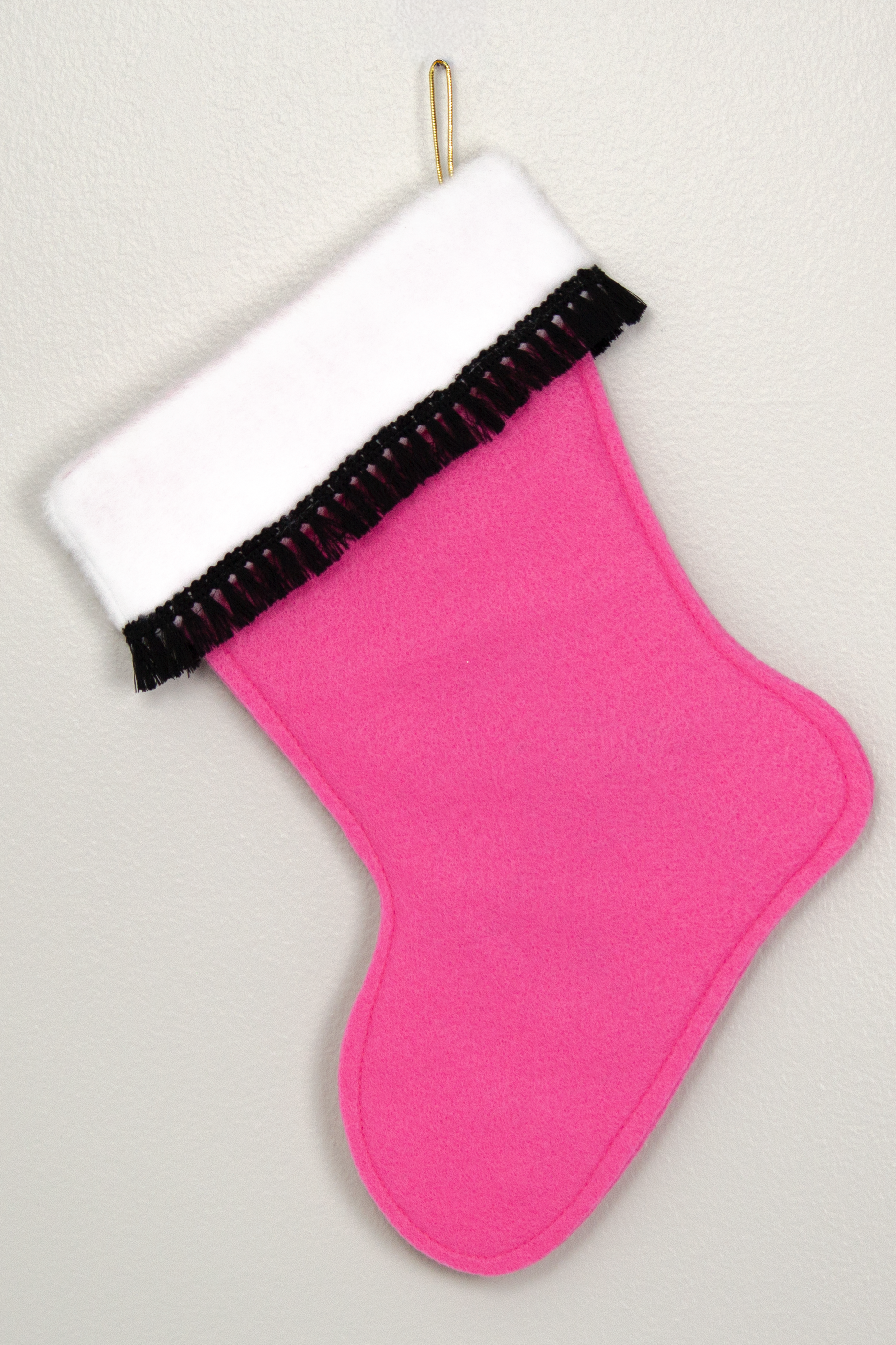Back of pink Christmas stocking with black poodle 