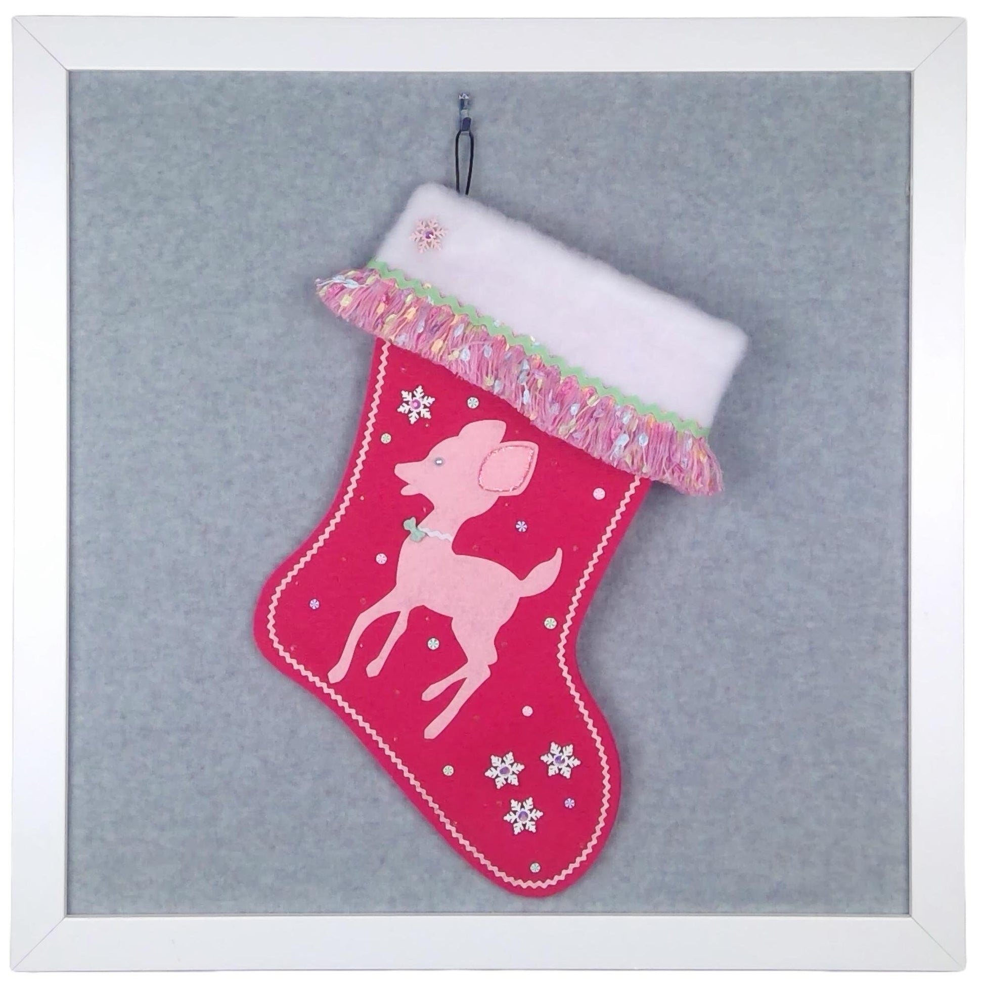Light pink retro deer on shocking pink felt one of a kind handmade Christmas stocking with multicolor fringe, white od snowflakes, mint green decoration, and silver accents.