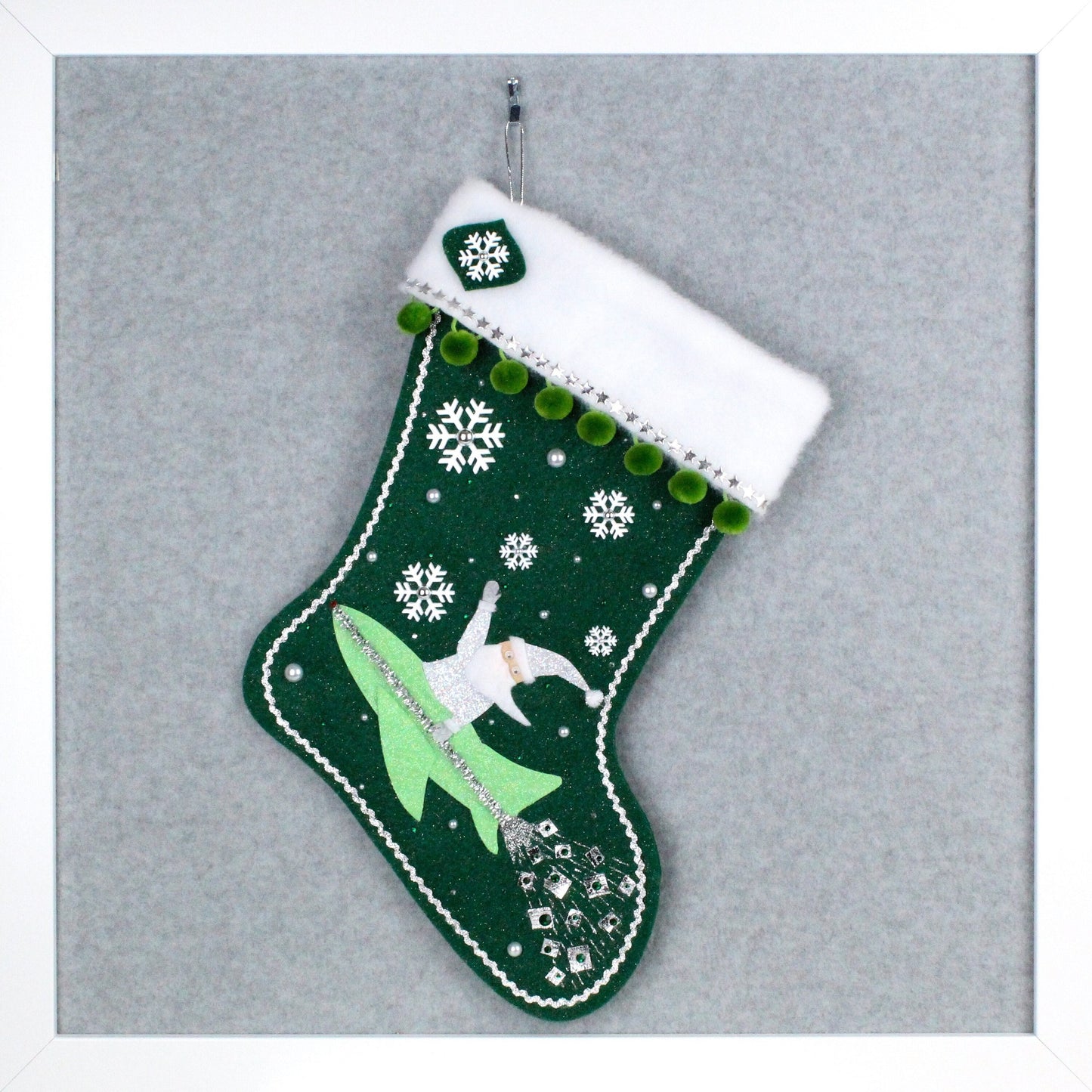 Silver glittery Santa Claus in a rocket on dark green glitter felt handmade one of a kind Christmas stocking with silver stars, white snowflakes green pom poms and silver decoration.