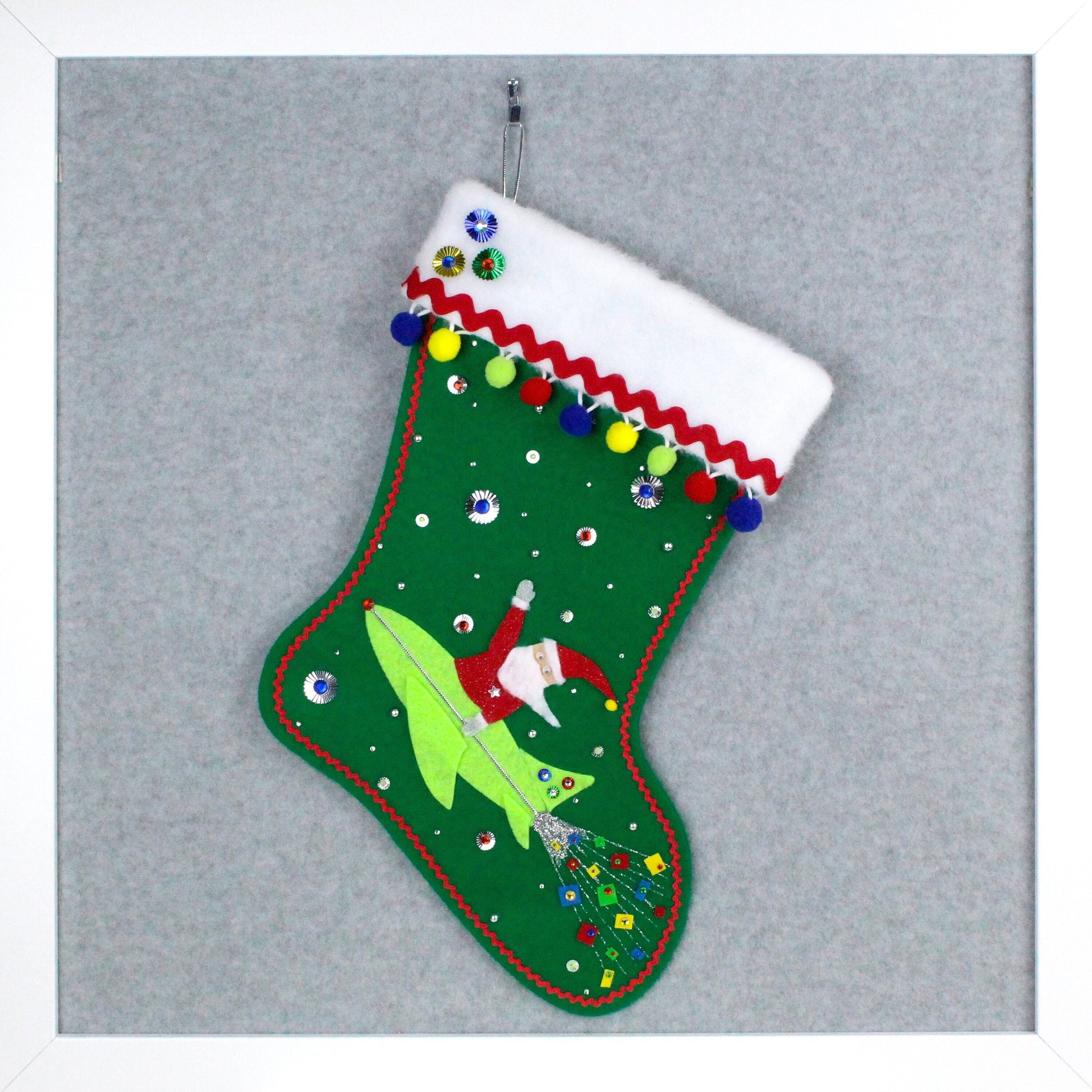 Red Santa Claus in a neon green rocket on holiday green felt handmade OOAK Christmas stocking with silver and multicolor primary decoration.