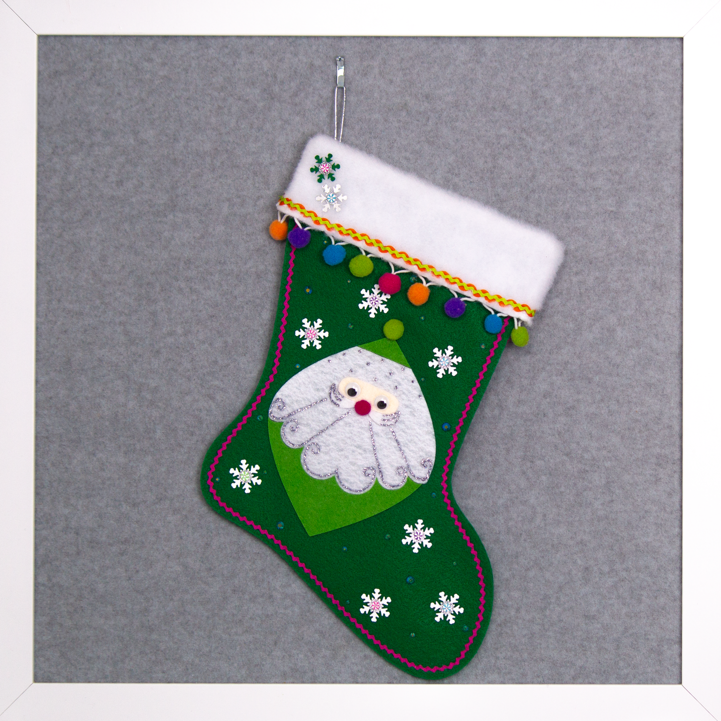 Marquise shaped Santa in green on a holiday green felt handmade Christmas stocking with snowflake sequins, clay candy pieces, pom poms and decorated in orange, purple, blue, greens, hot pink & silver. (front of stocking)