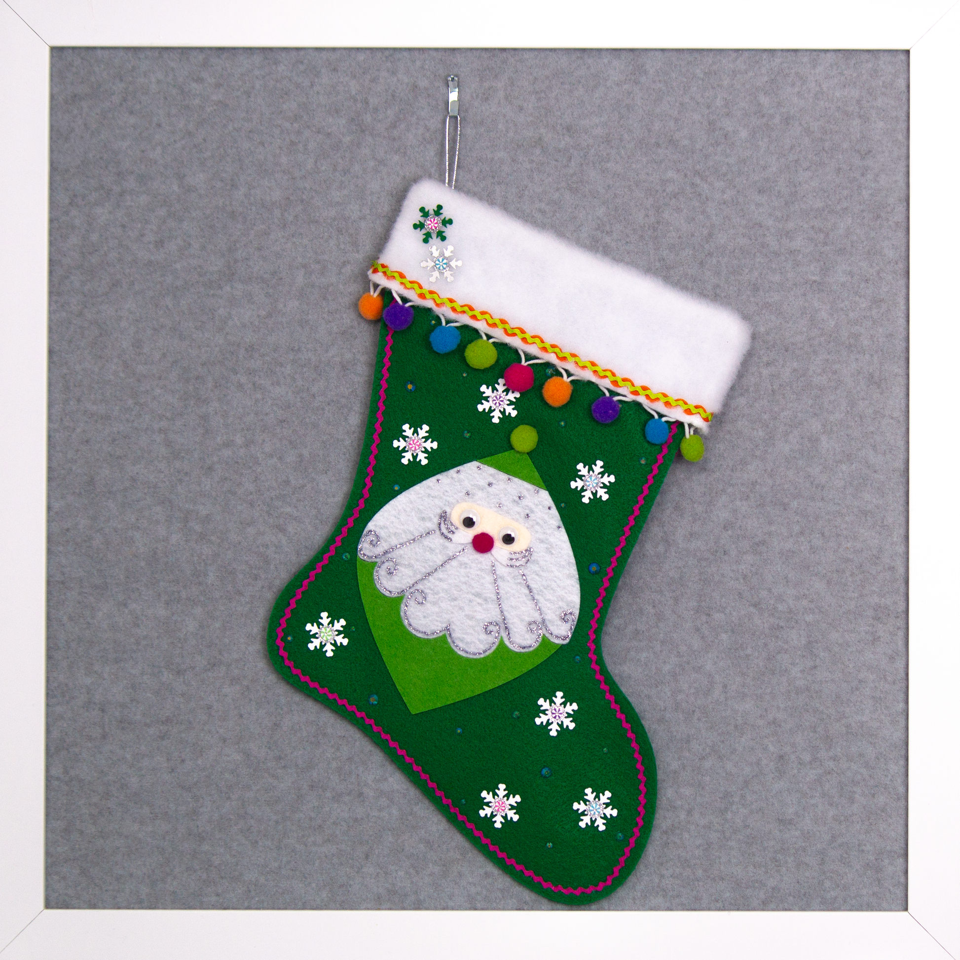 Marquise shaped Santa in green on a holiday green felt handmade Christmas stocking with snowflake sequins, clay candy pieces, pom poms and decorated in orange, purple, blue, greens, hot pink & silver. (front of stocking)
