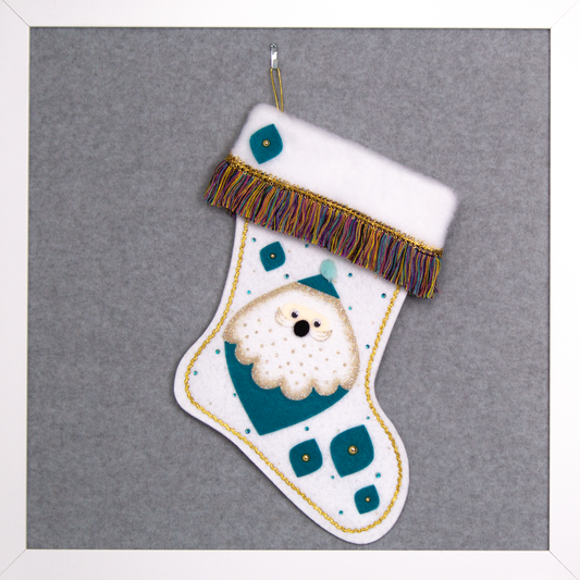 Marquise shaped Santa head (Holt Howard inspired) in turquoise with a gold glittered beard on a glitter white felt handmade Christmas stocking - felt marquise shapes, multicolored fringe  and decorated in turquoise & gold. (front of stocking)