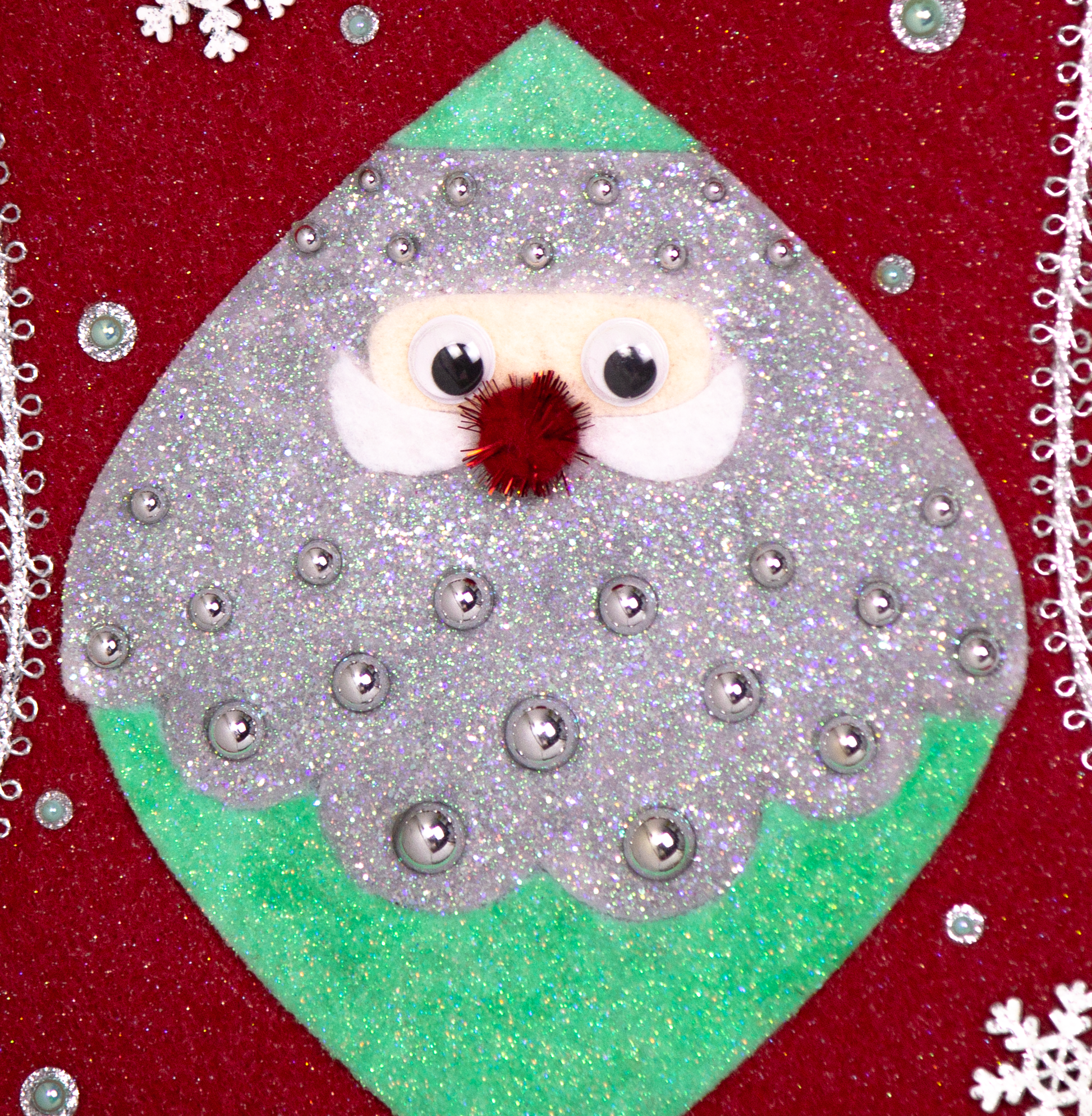 Marquise shaped Santa head (Holt Howard inspired) in silver and mint green glitter on a red glitter felt handmade Christmas stocking with wood snowflakes, pom poms and decorated in red, mint green & silver. (close up detail of stocking)