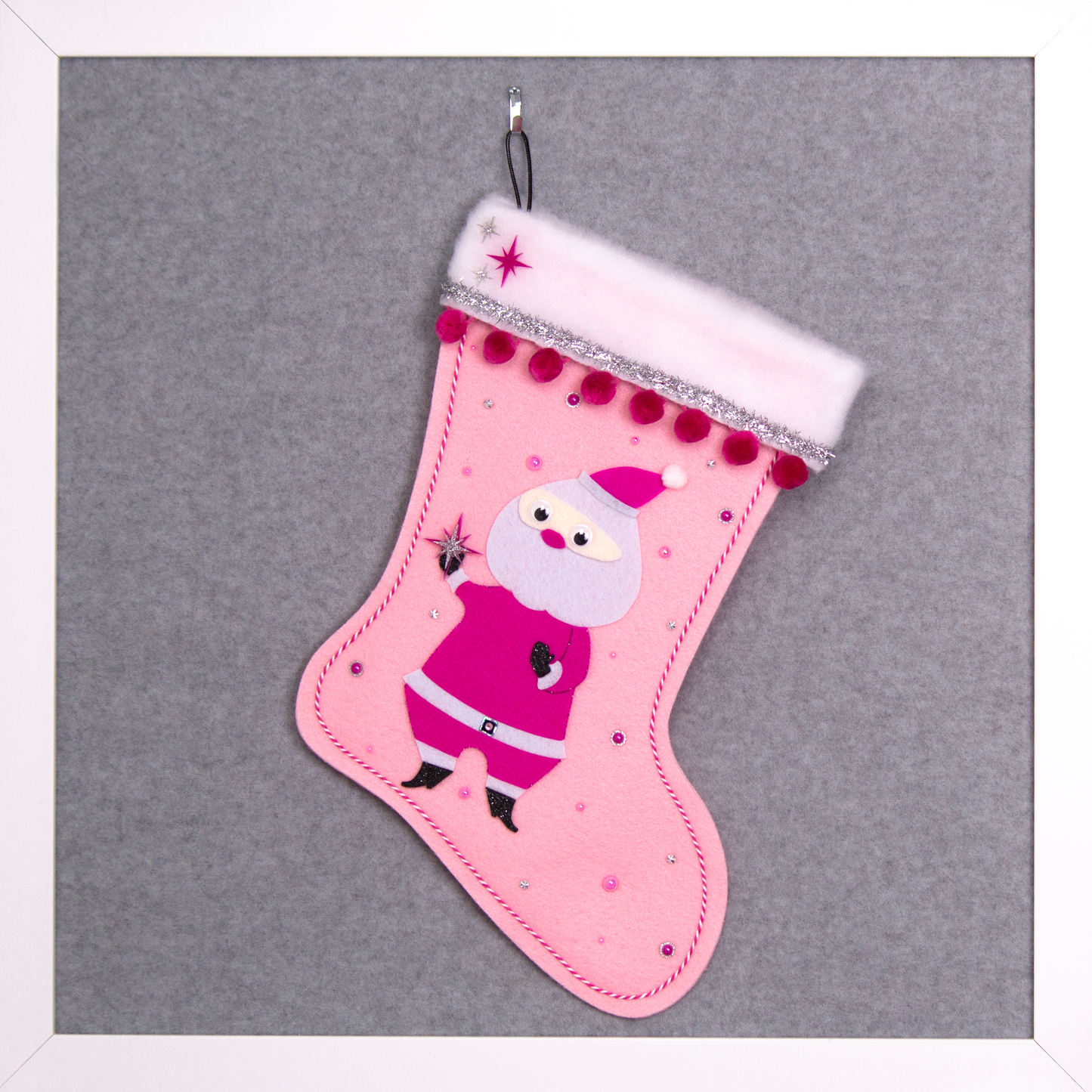 Retro Santa in hot pink suit on light pink felt handmade Christmas stocking with pom poms, tinsel ribbon and decorated in black, pinks & silver. (front of stocking)
