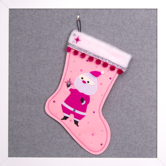 Retro Santa in hot pink suit on light pink felt handmade Christmas stocking with pom poms, tinsel ribbon and decorated in black, pinks & silver. (front of stocking)