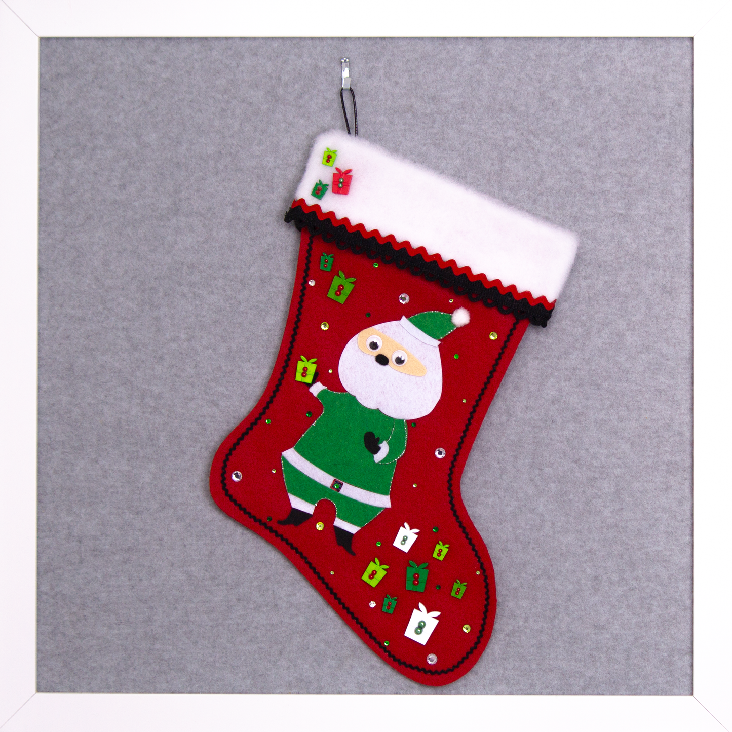 Retro Santa in green suit on a holiday red felt handmade Christmas stocking with boxes and decorated in black, white, greens and silver. (front of stocking)